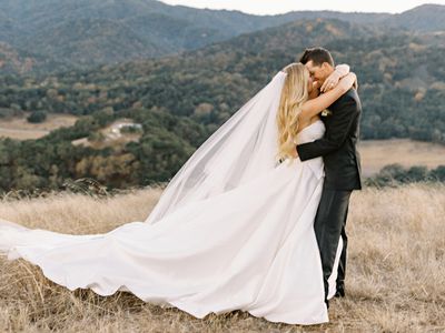 bride and groom hugging amongst a mountainous backdrop