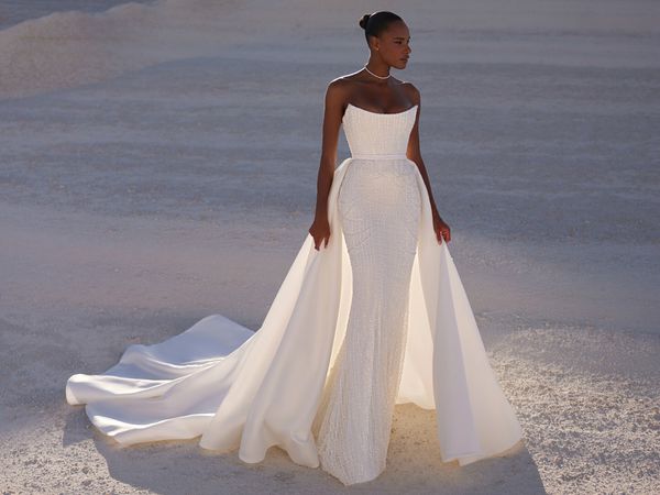 Bride wearing a strapless gown with an overskirt