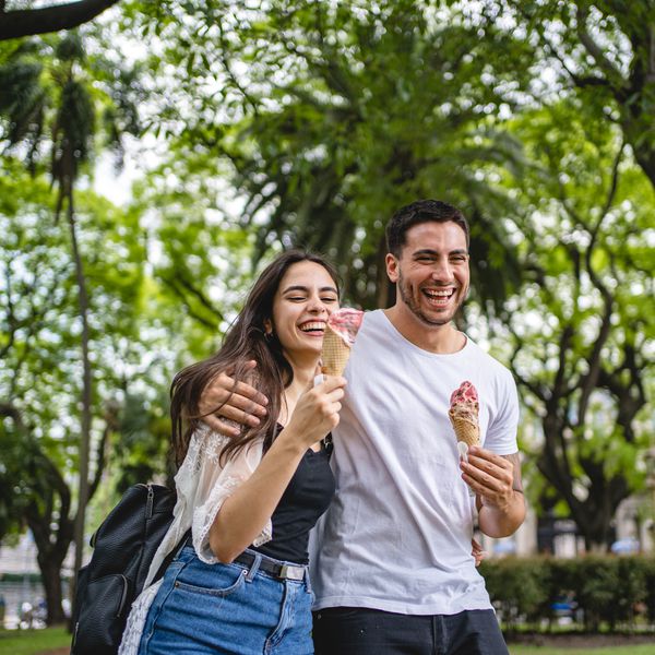 Couple eating ice cream while on a walk outdoors