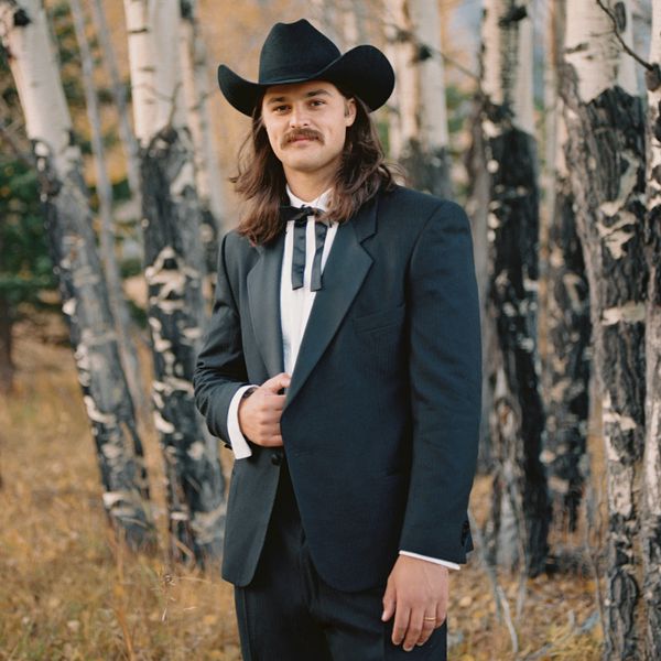 Olympic Hammer Thrower Rowan Hamilton wearing a cowboy hat and wedding tuxedo