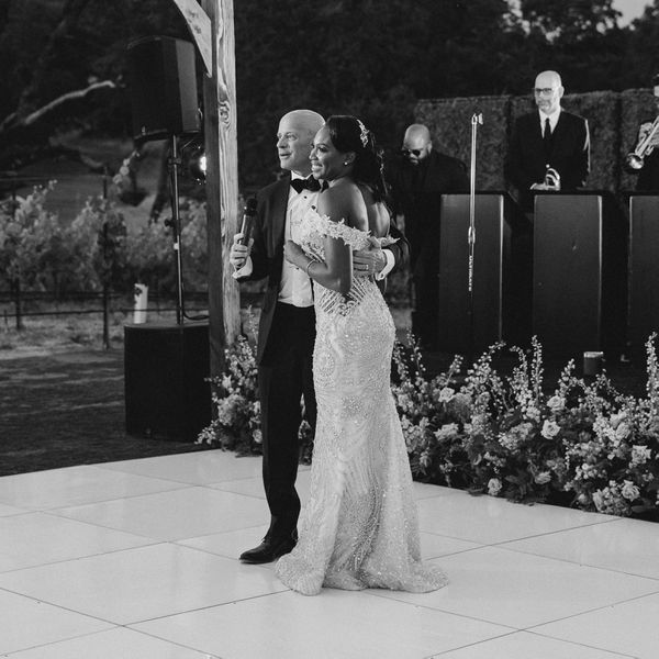 Groom giving a speech at this wedding reception with his wife