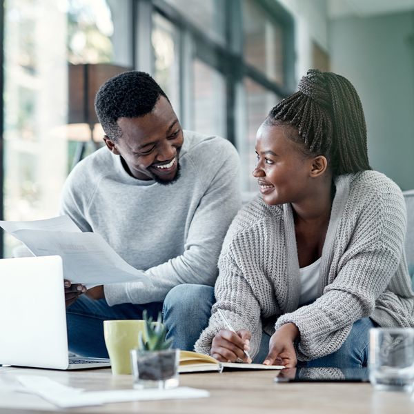 Shot of a young couple going through paperwork at home