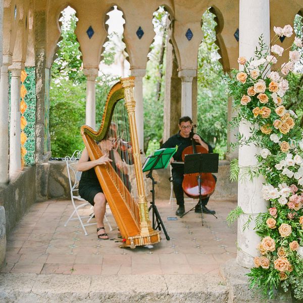 Musicians playing the harp, violin, and cello