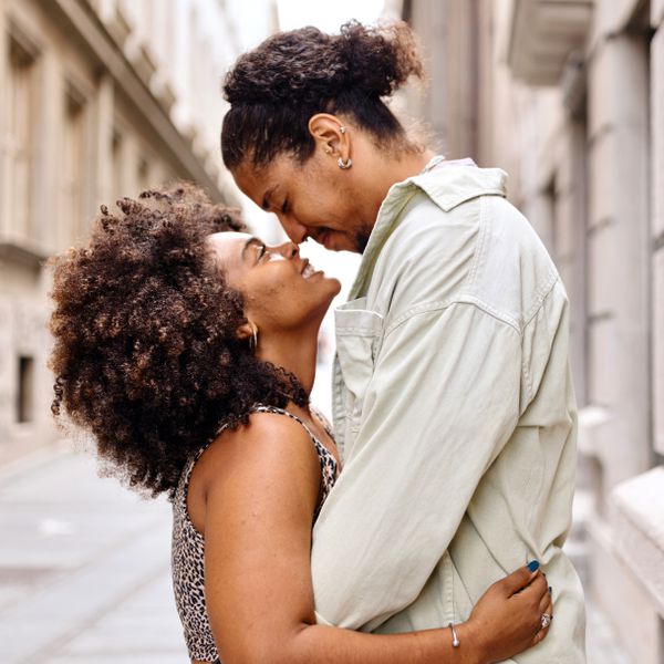 man and woman kissing and hugging on the street