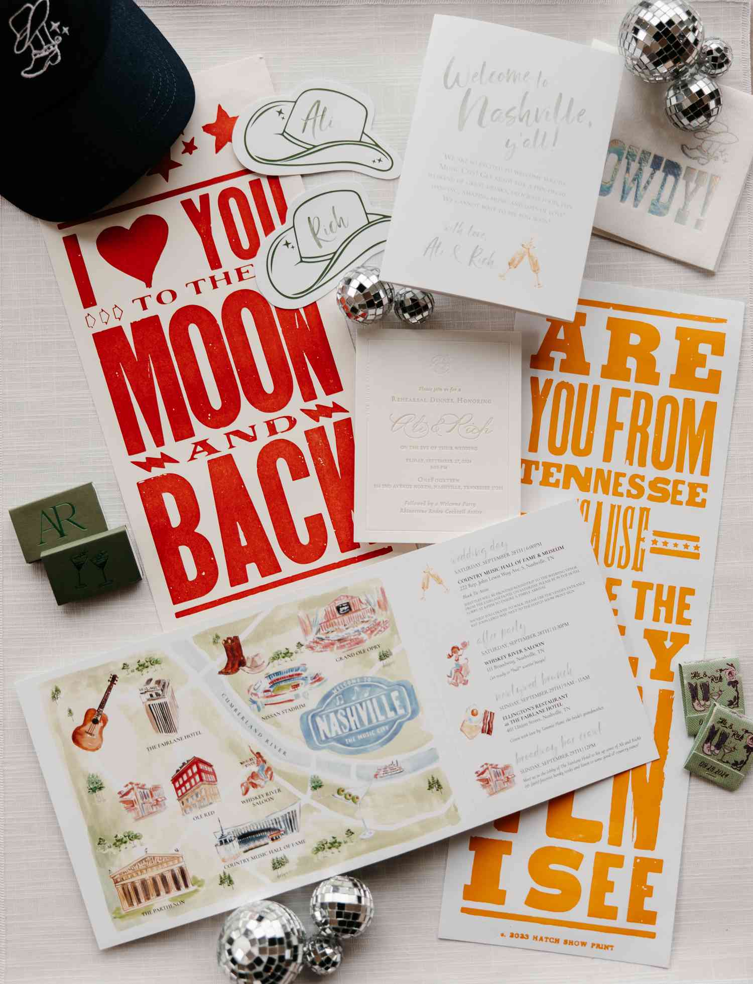 Cowboy theme colorful invitations with map of nashville next to mini disco balls and matches