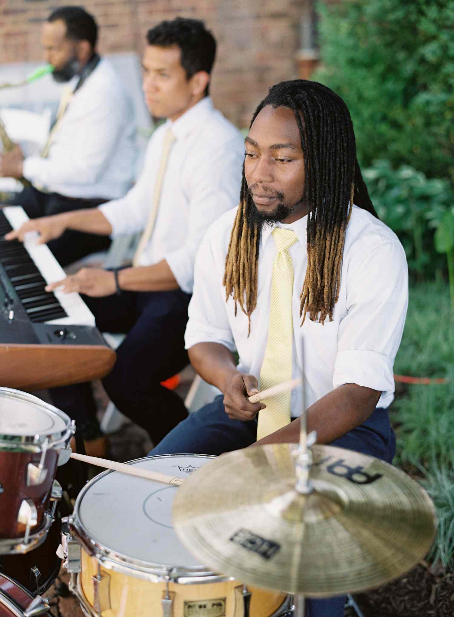 A Musician Plays the Drums Before a Bride and Groom's Wedding Entrance
