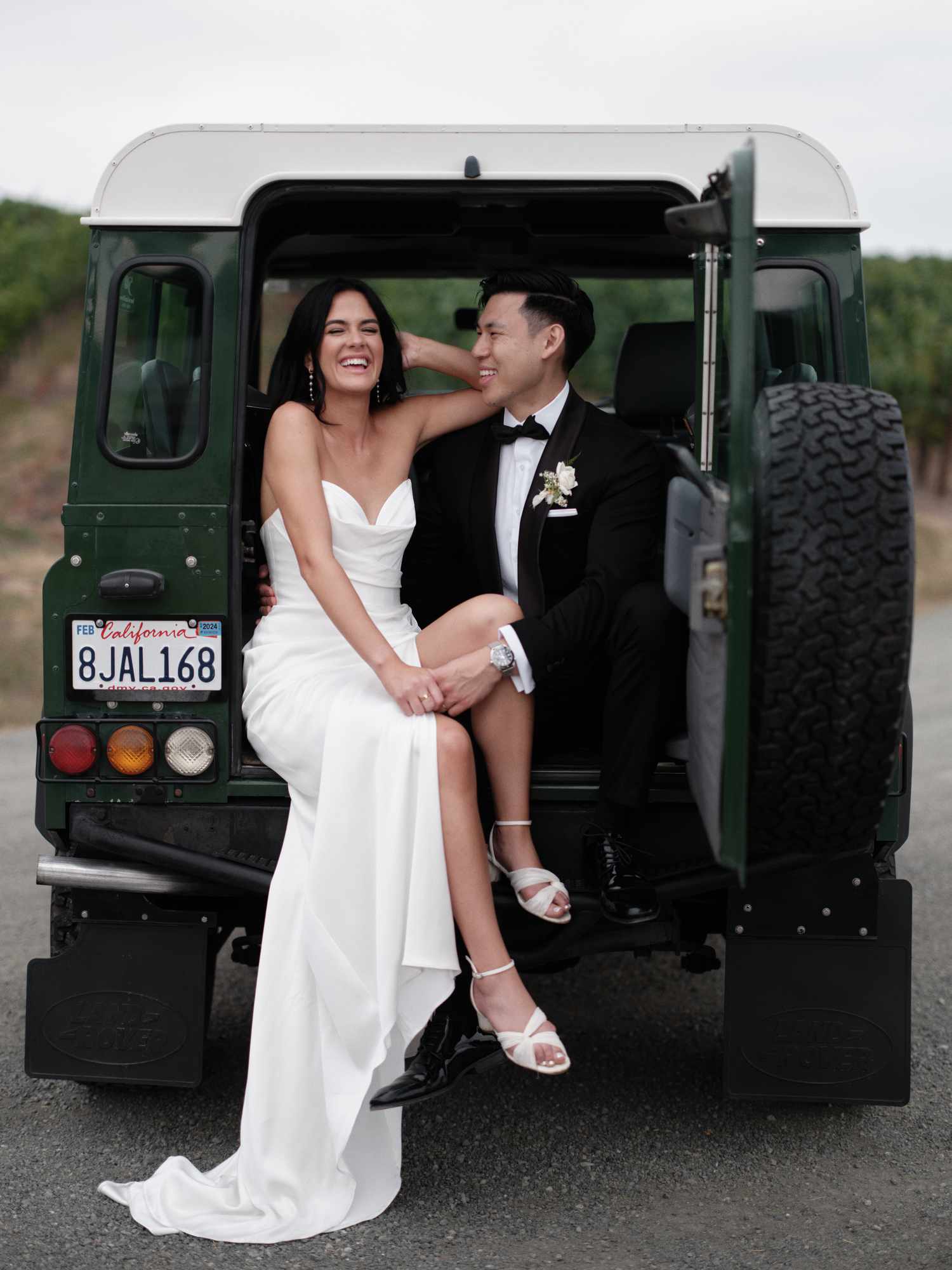 A Bride and Groom Pose in Their Getaway Car Before Making Their Wedding Entrance