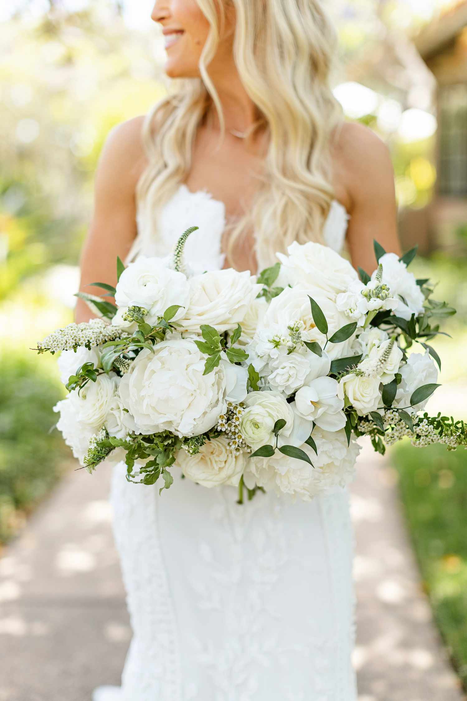 Bride Holding White Wedding Bouquet With Peonies and Roses