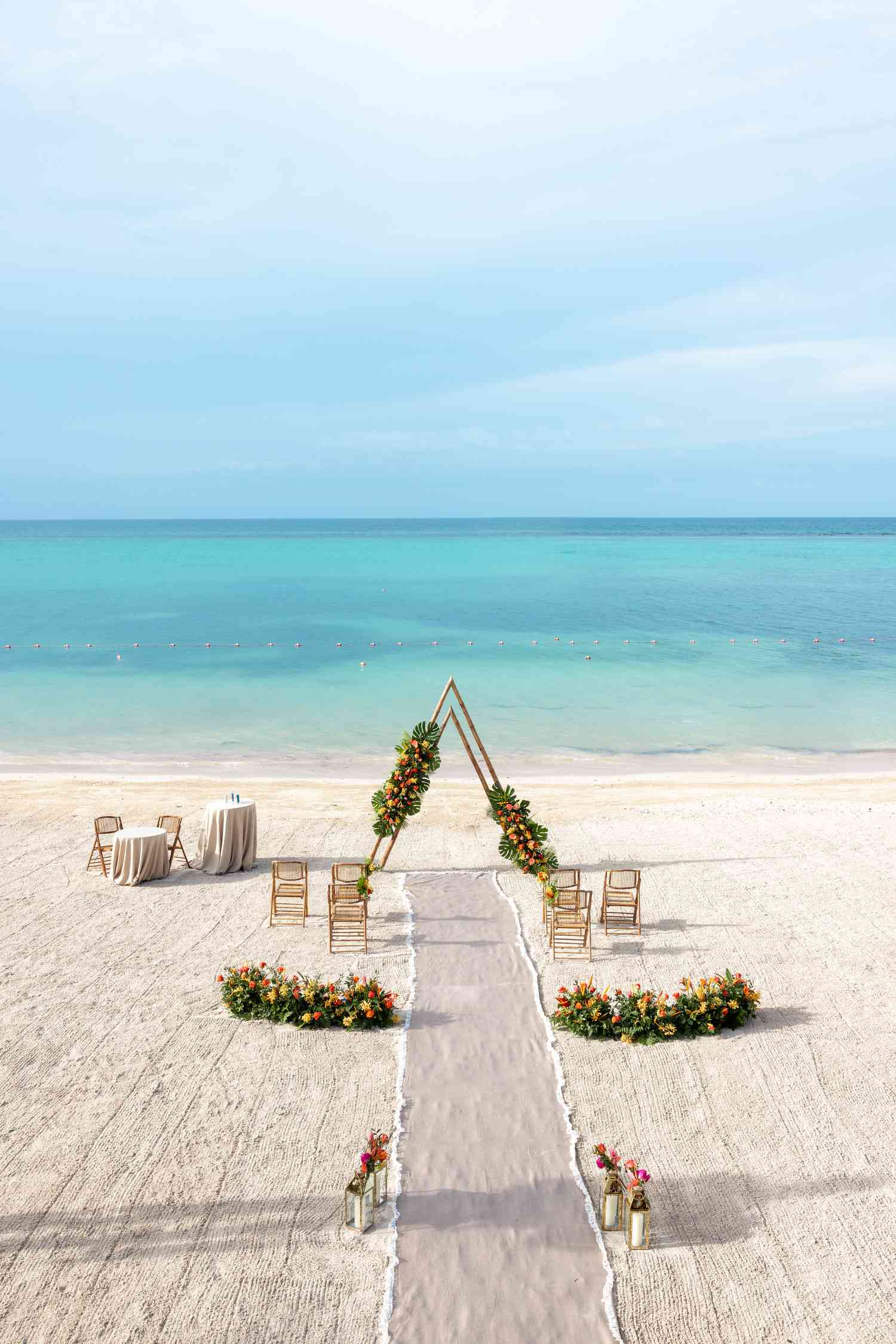 Small Beach Wedding Ceremony Decor With Colorful Flower Decor by The Ocean