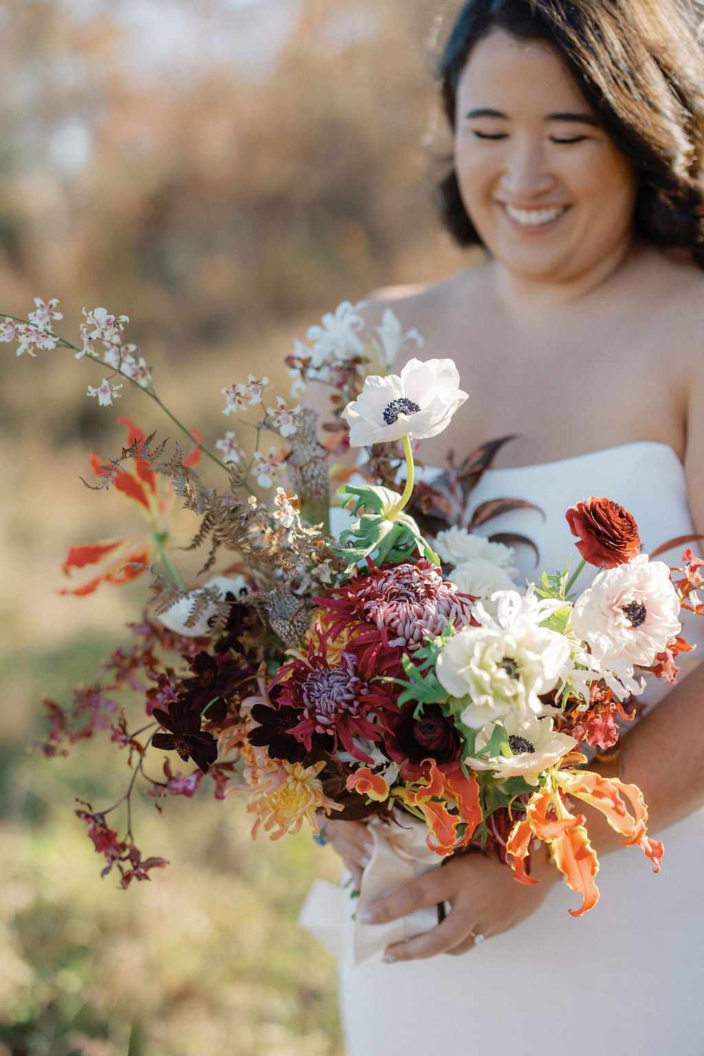 Bride in Strapless Wedding Dress Holding Colorful Bouquet