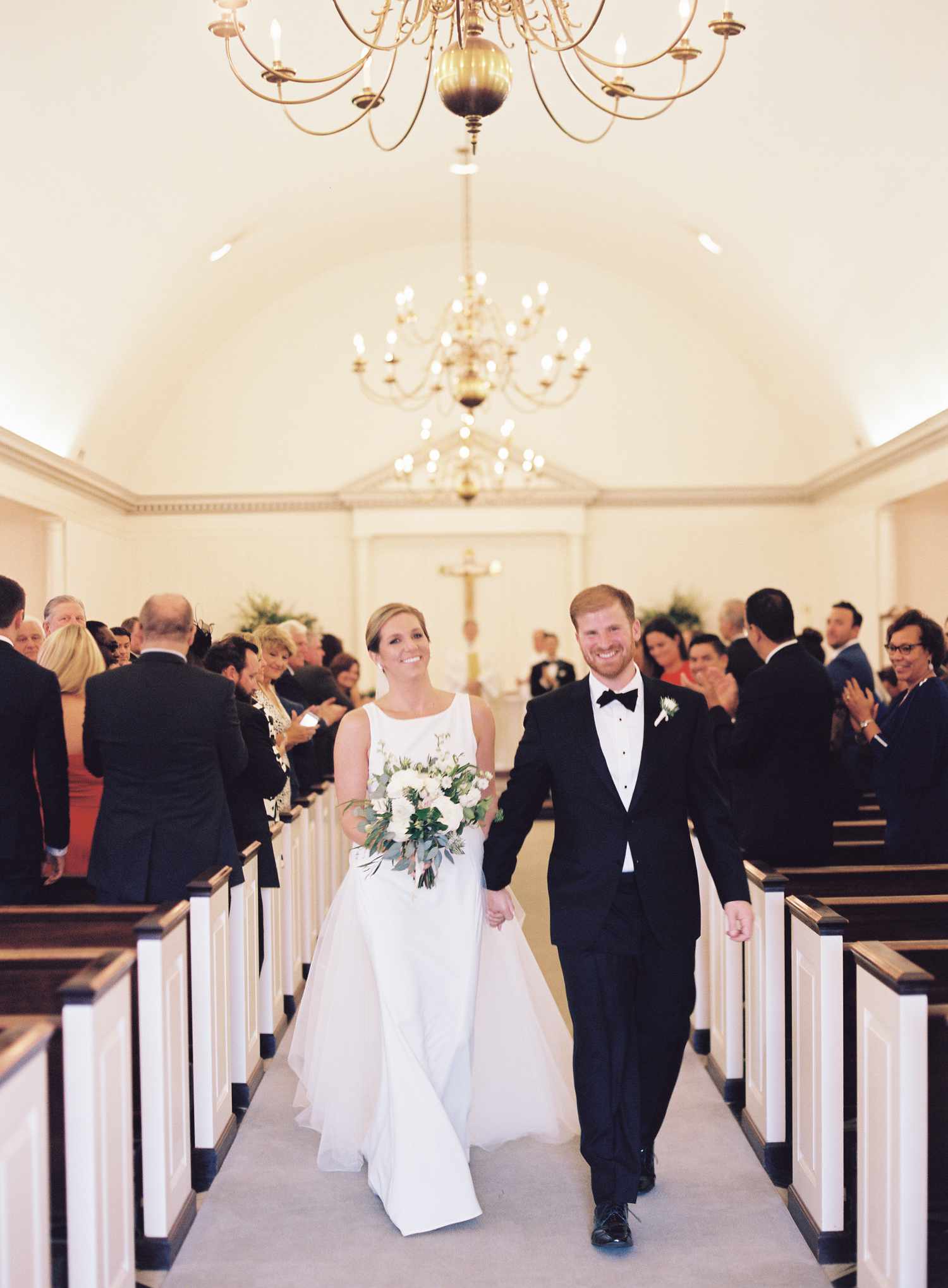 Bride and Groom Leaving Christian Wedding Ceremony, Smiling During Recessional