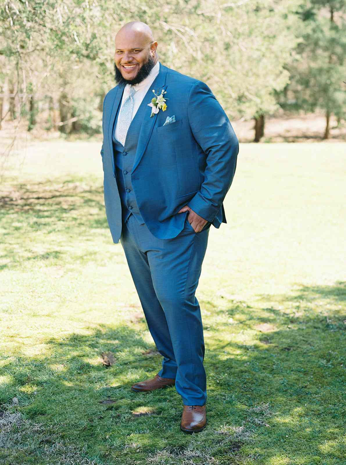 Portrait of Groom in Blue Suit and Brown Shoes Posing on Grass