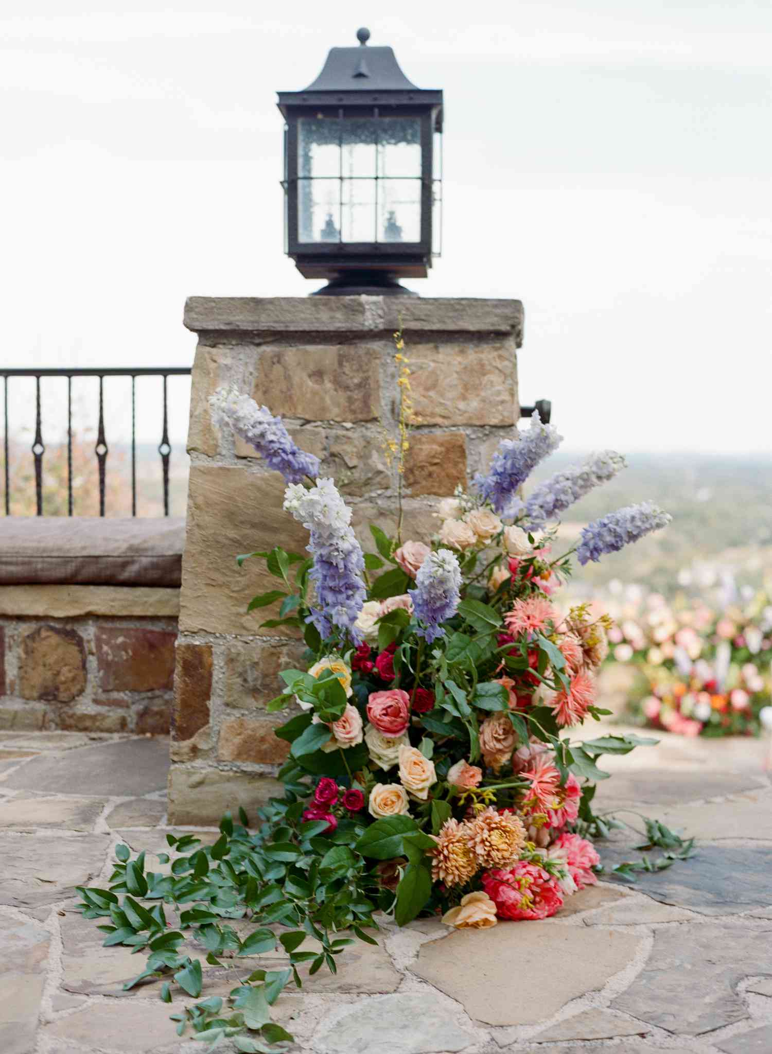 Colorful Flower Decor at Top of Stone Staircase At Wedding Venue