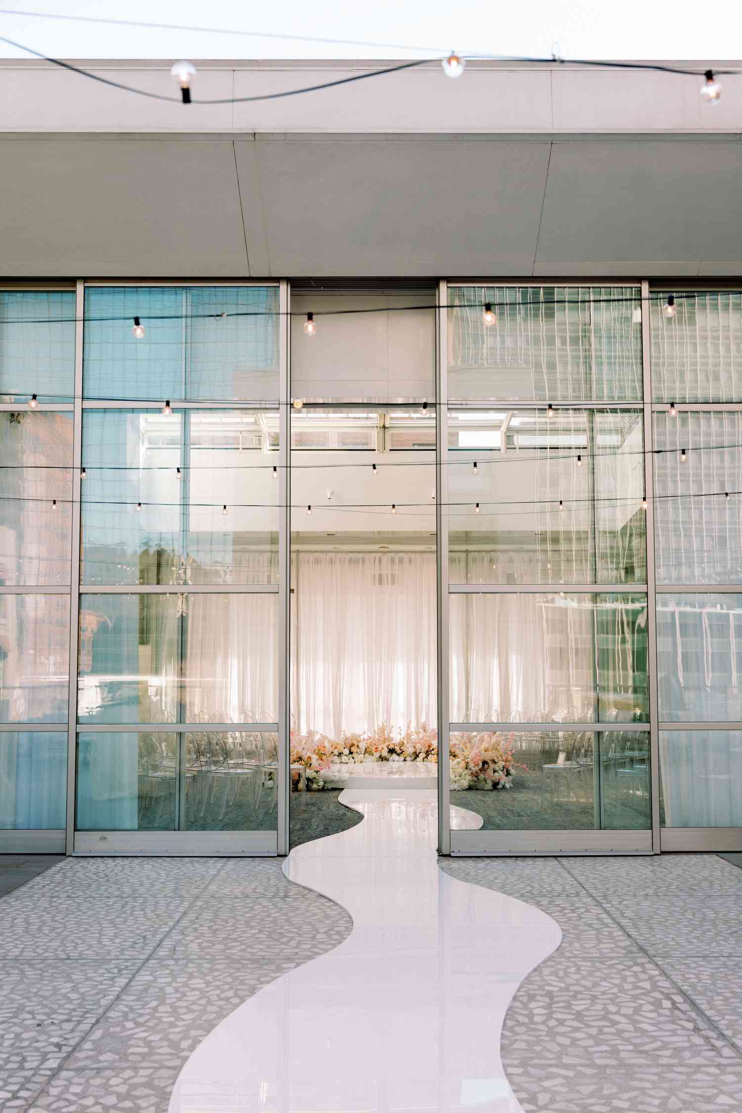 walkway leading into two large glass sliding doors