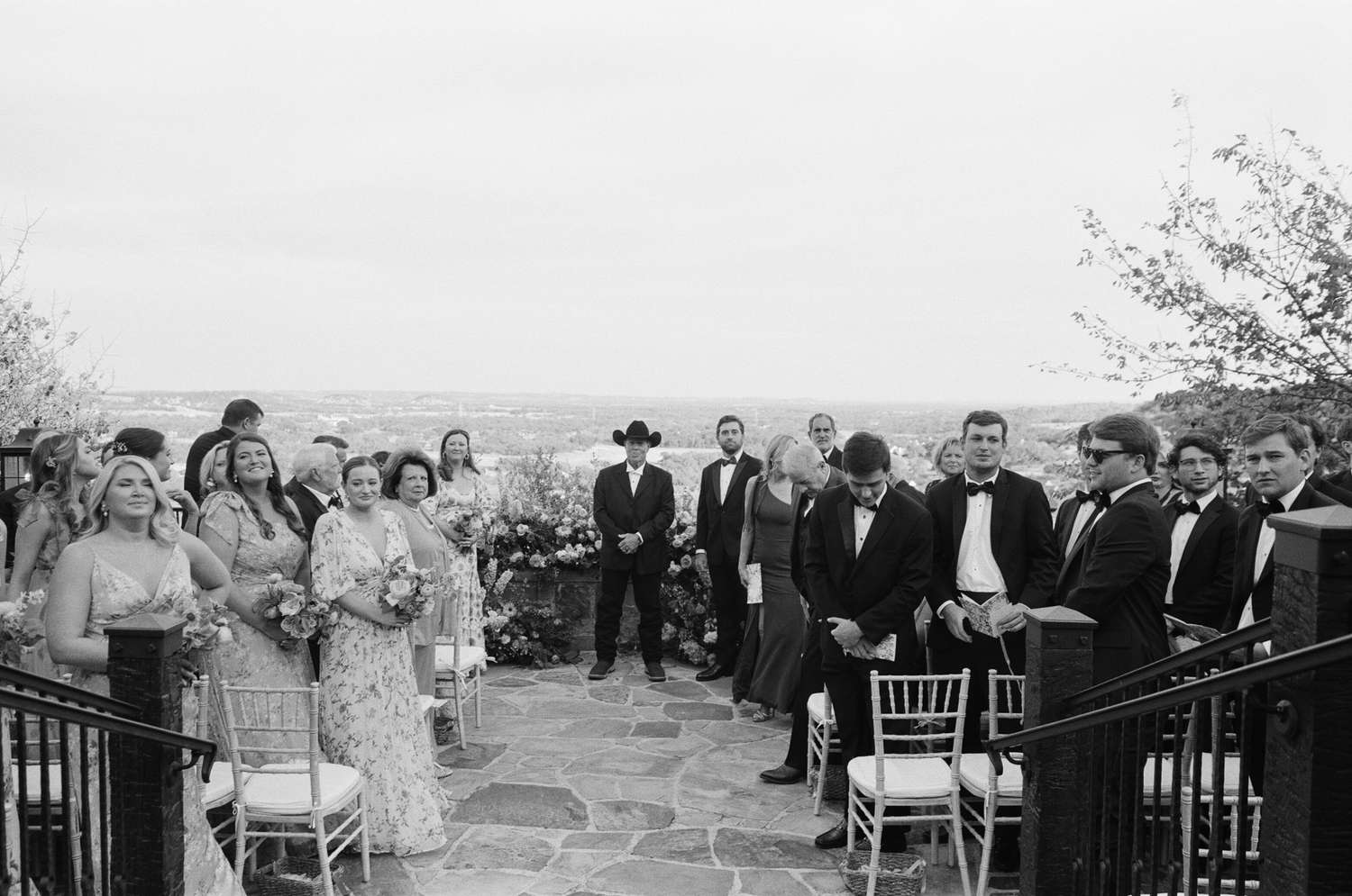 Black and White Image of Groom Standing at Altar With Wedding Party
