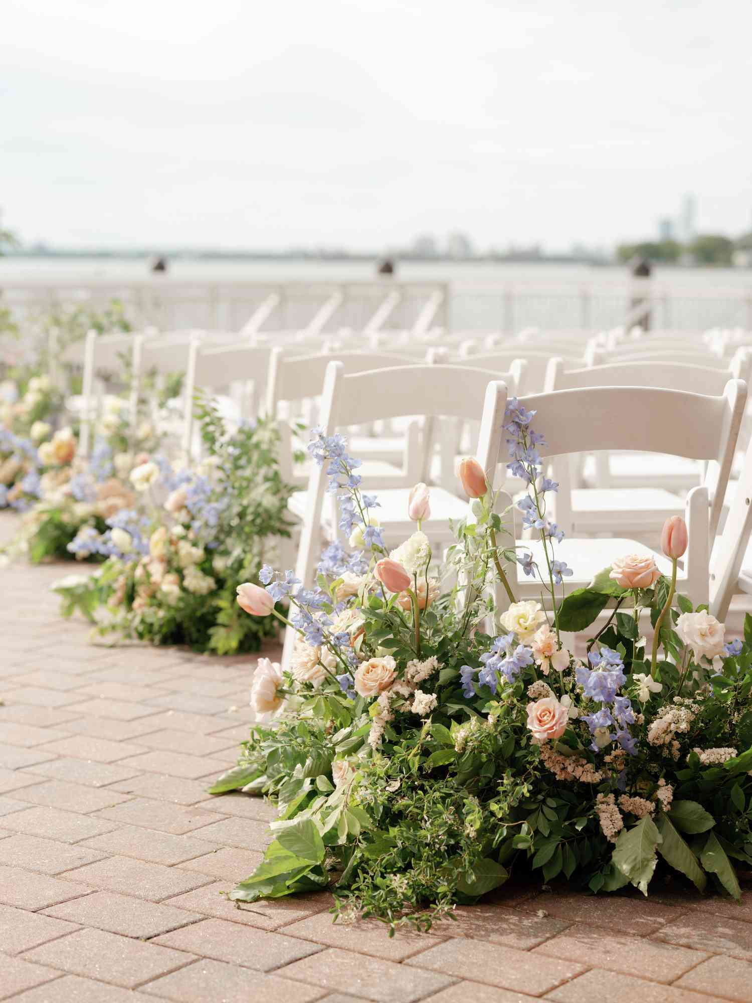 wedding aisle with pink, purple, and peach arrangements