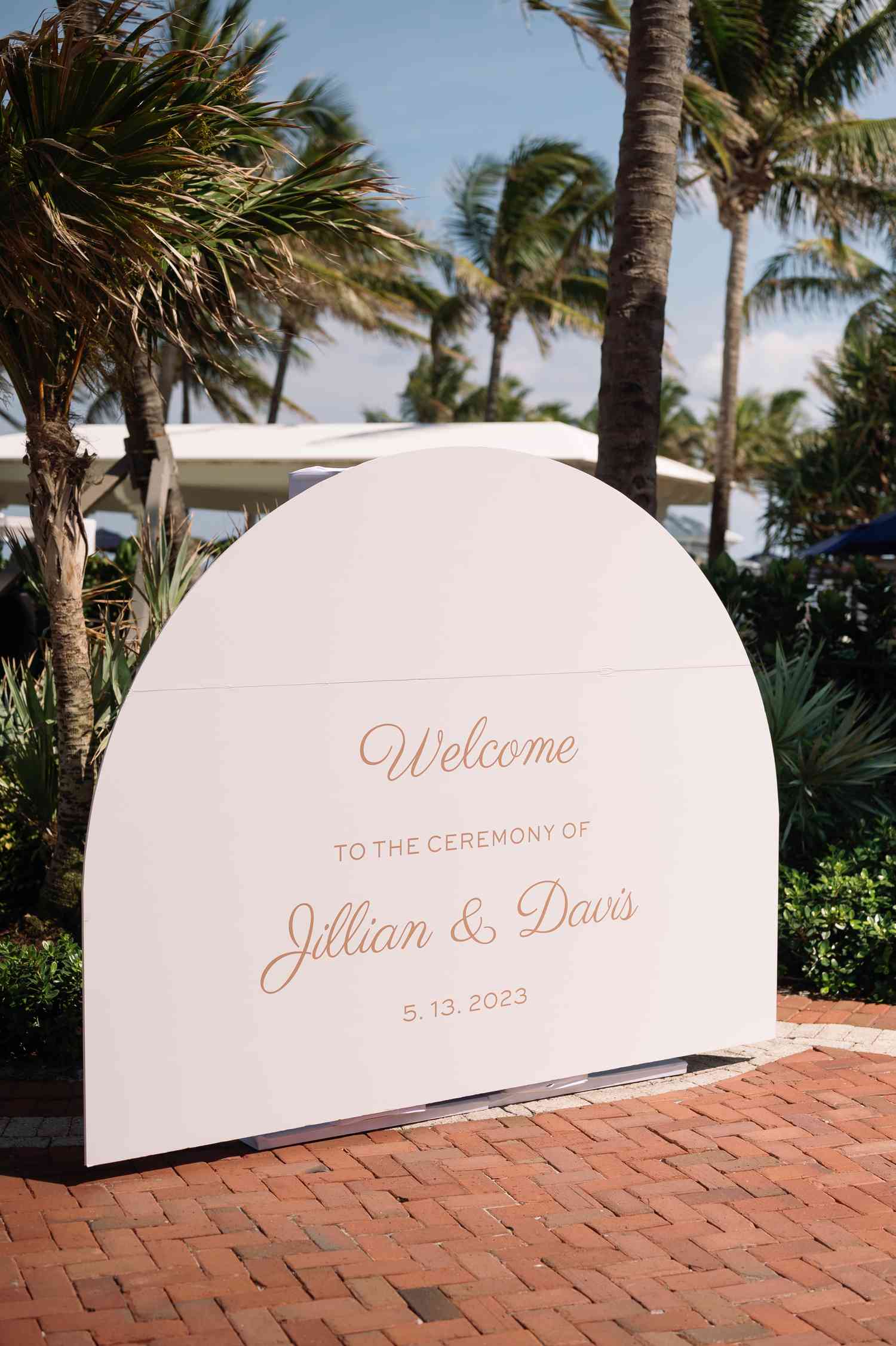 Dome Shaped Wedding Welcome Sign in Front of Palm Trees