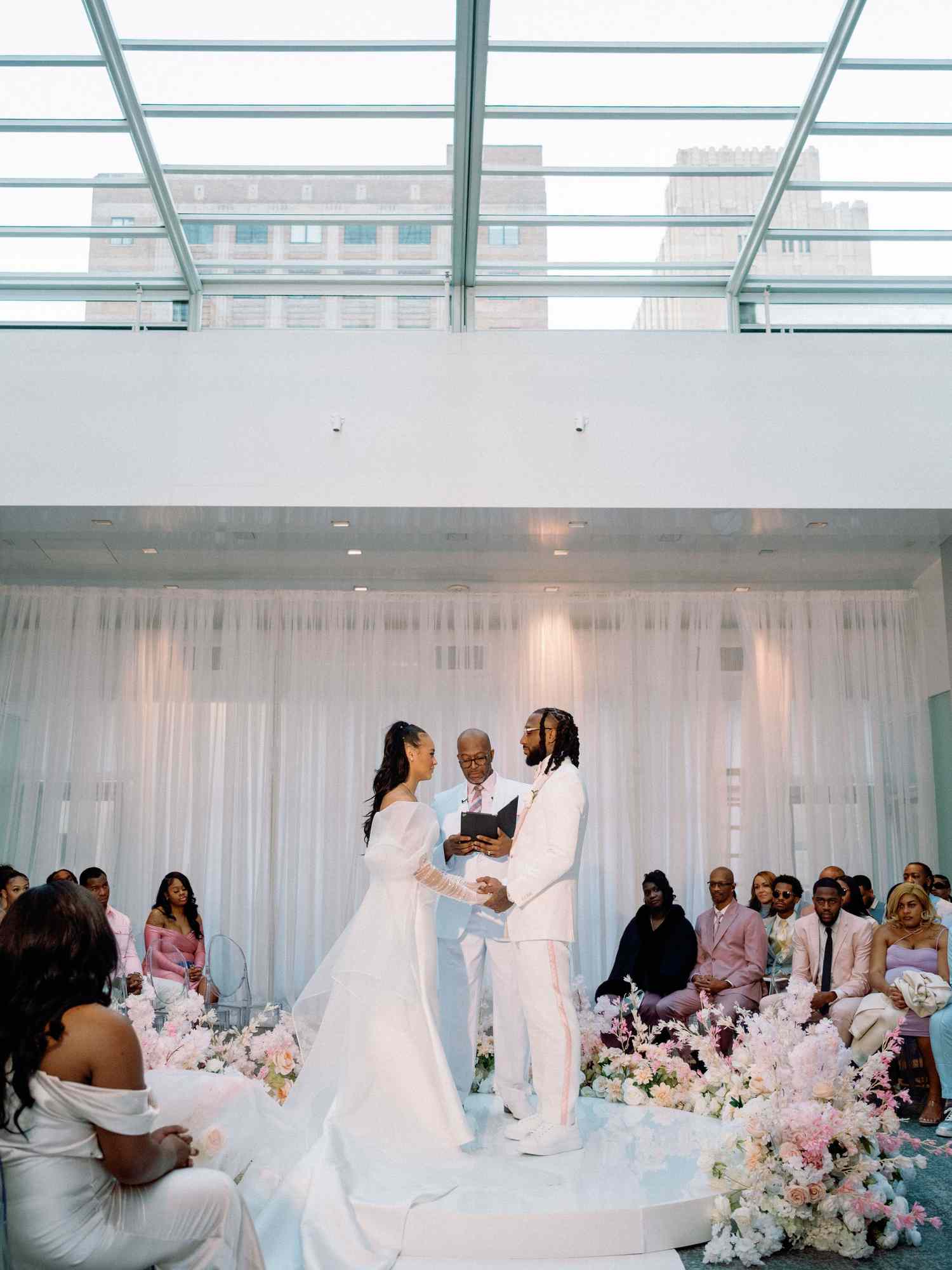 bride and groom at the alter holding hands
