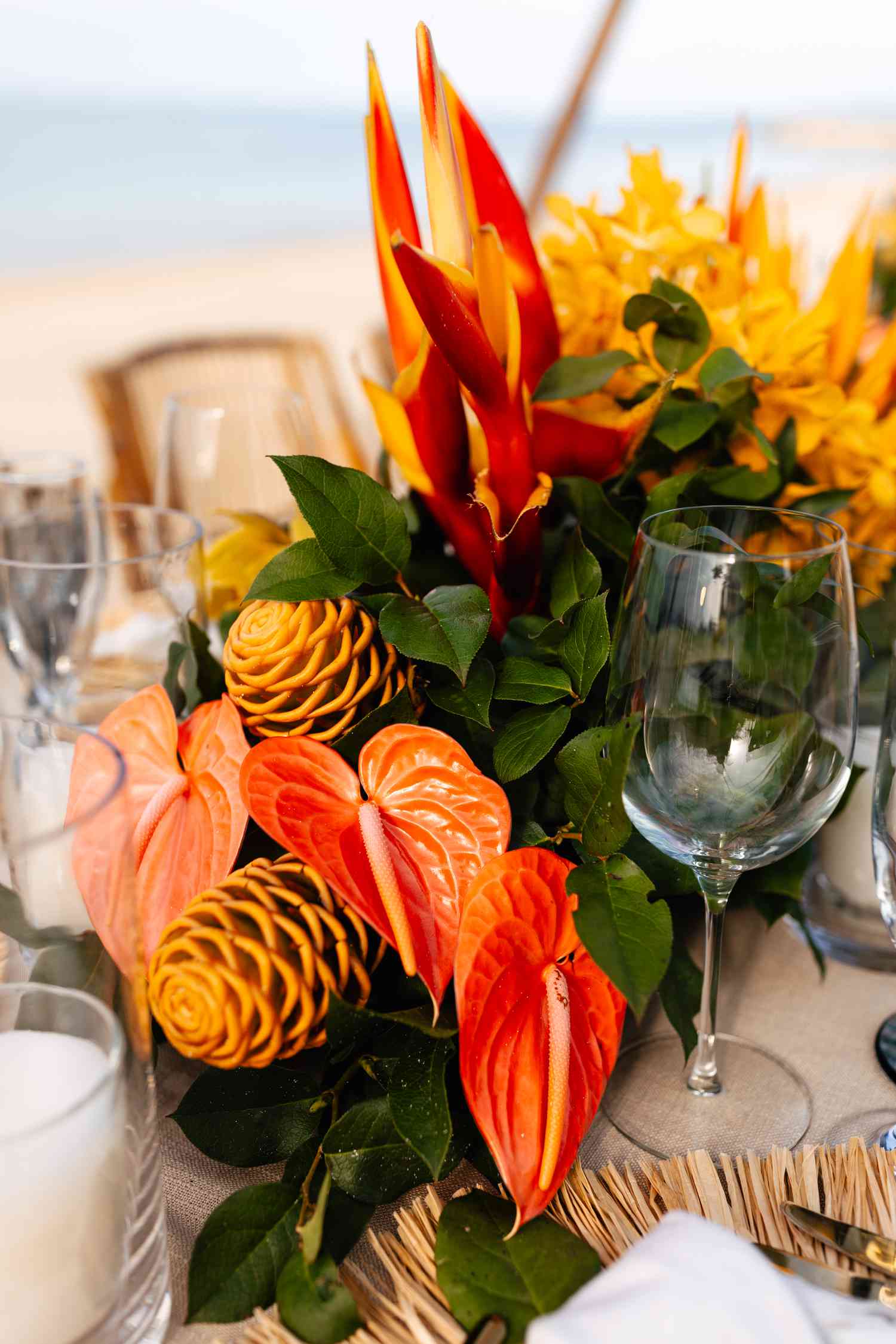 Colorful Tropical Flower Decor on Reception Table Next to Cocktail Glasses