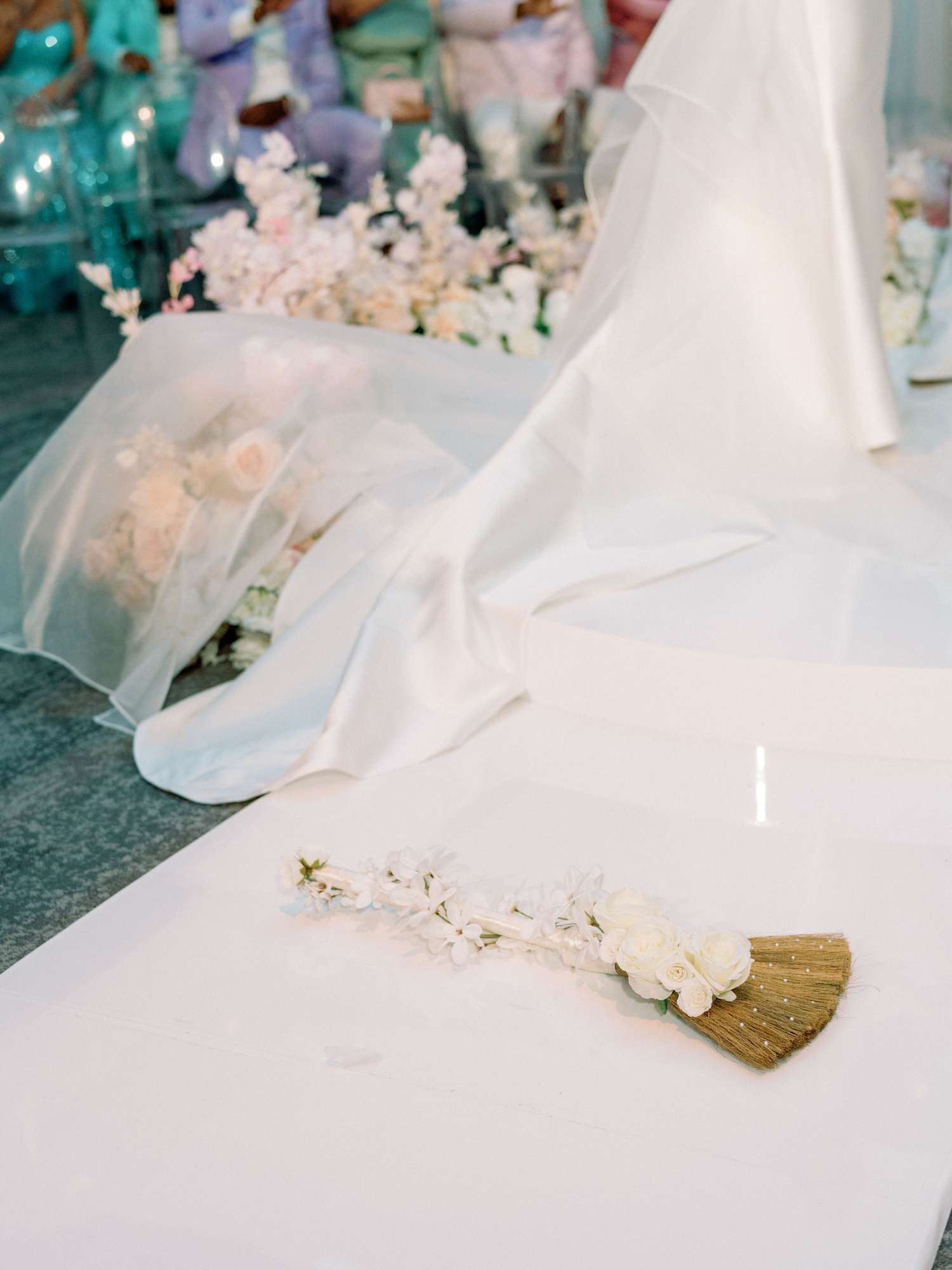 detail photo of dress train with wedding broom