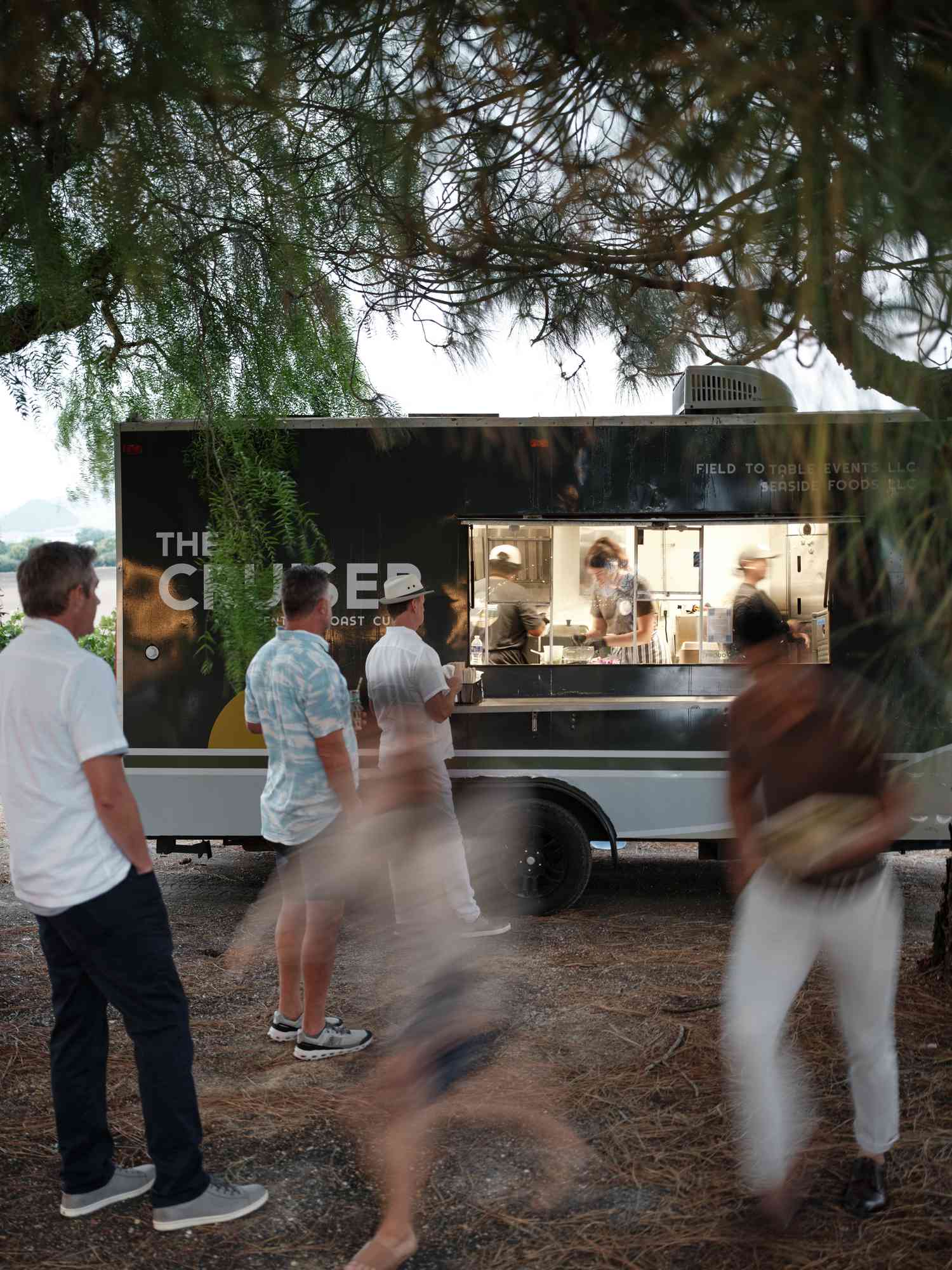 Black Food Truck With Wedding Guests in Casual Clothes in Front