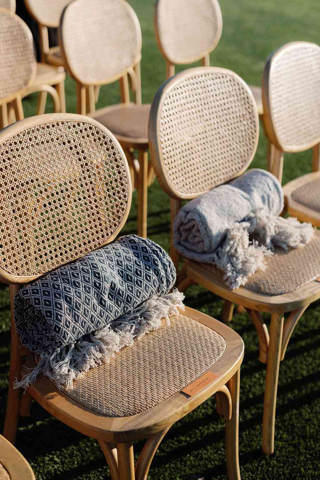 Blankets on Rattan Chairs at Wedding Ceremony