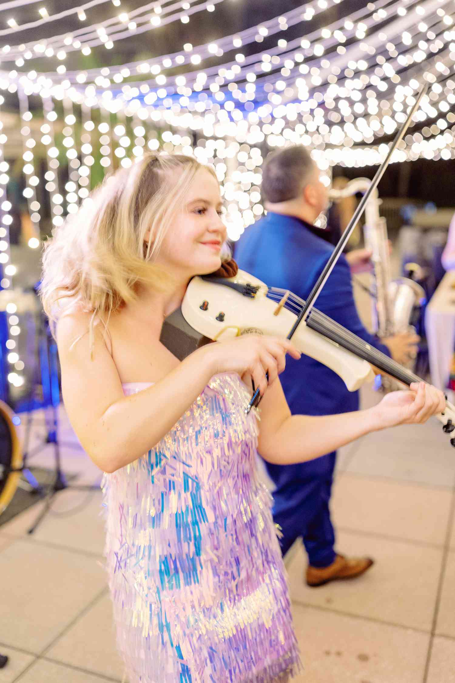 Violinist in Blue and Purple Dress Playing White Violin at Wedding Reception