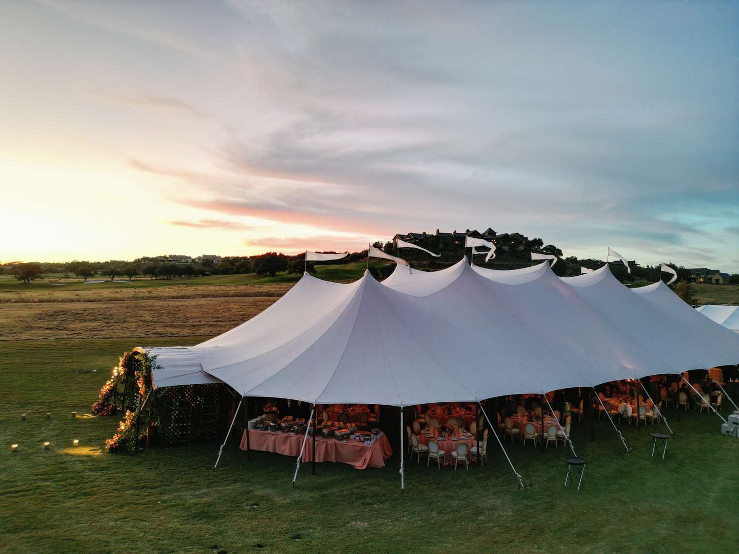 Wedding Reception Under White Tent On Grass Field