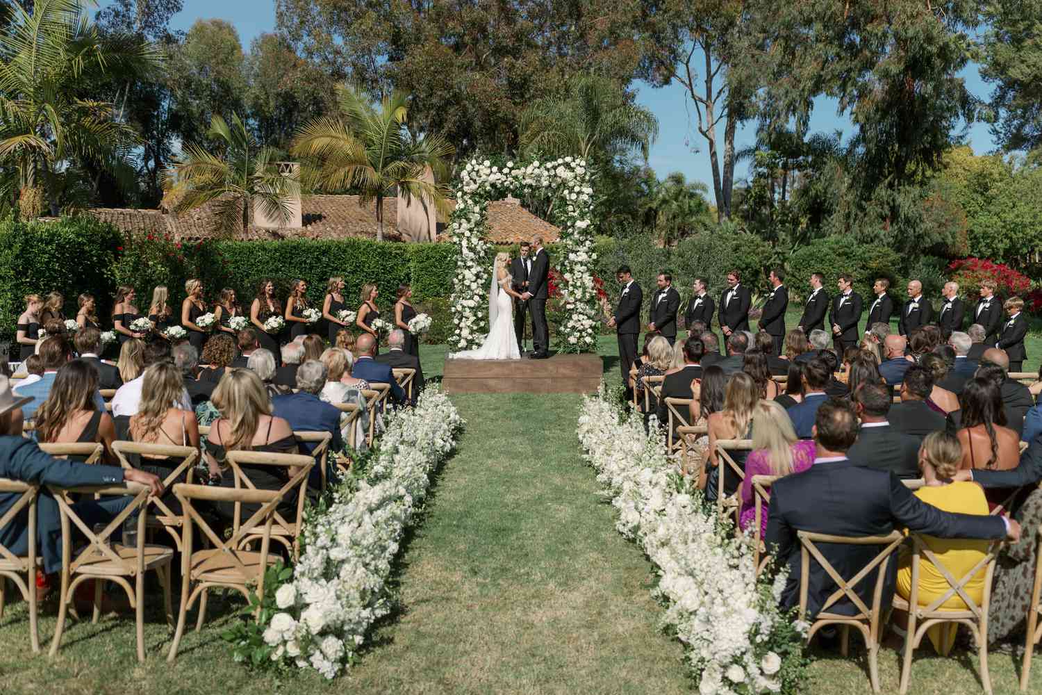 Olympic Volley Ball Player Chase Budinger and Bride's Outdoor Wedding Ceremony With Extra-Tall Arch and White Aisle Flower Arrangements