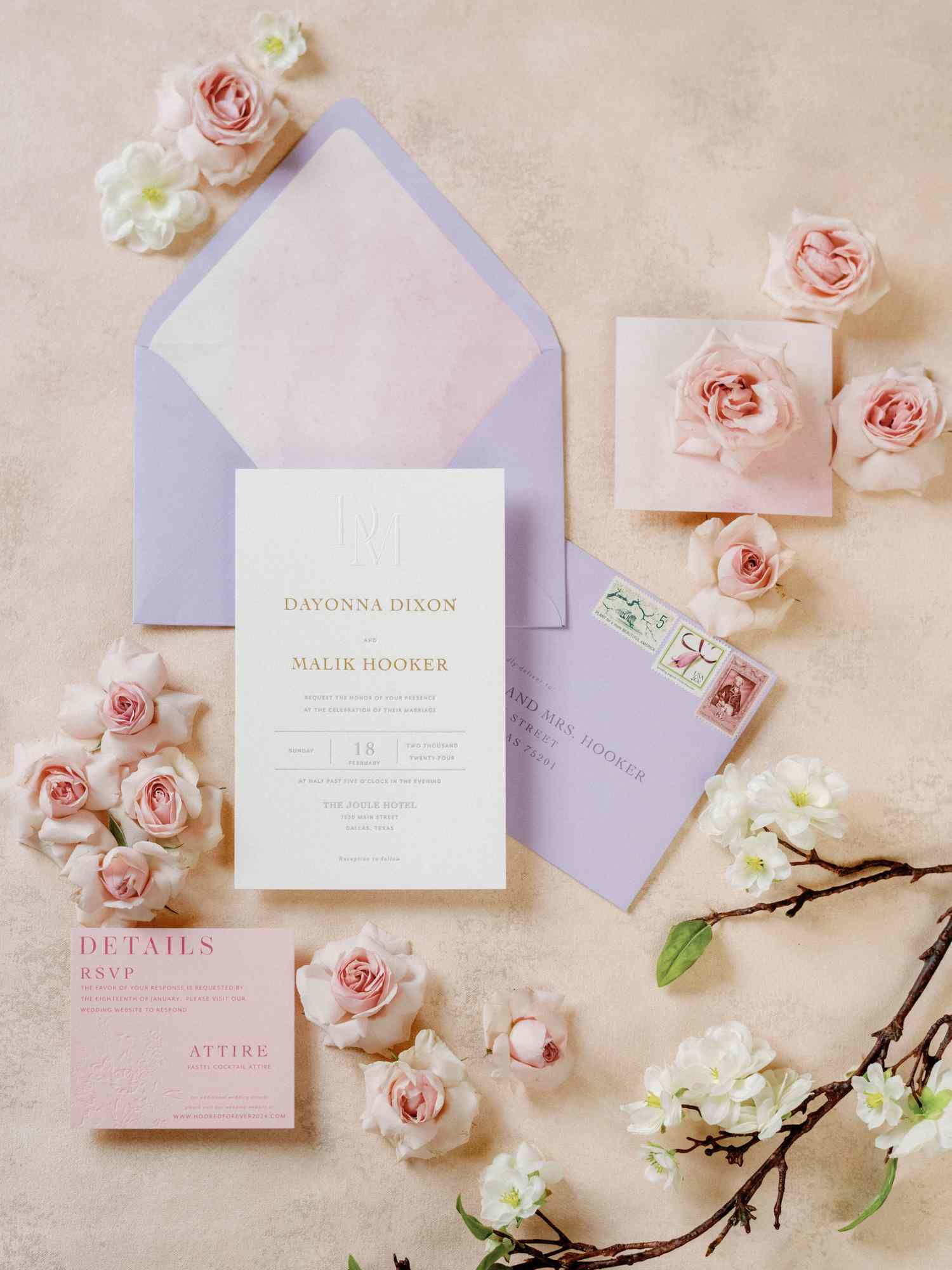 purple envelopes showcasing white invitation card with pink flowers around it