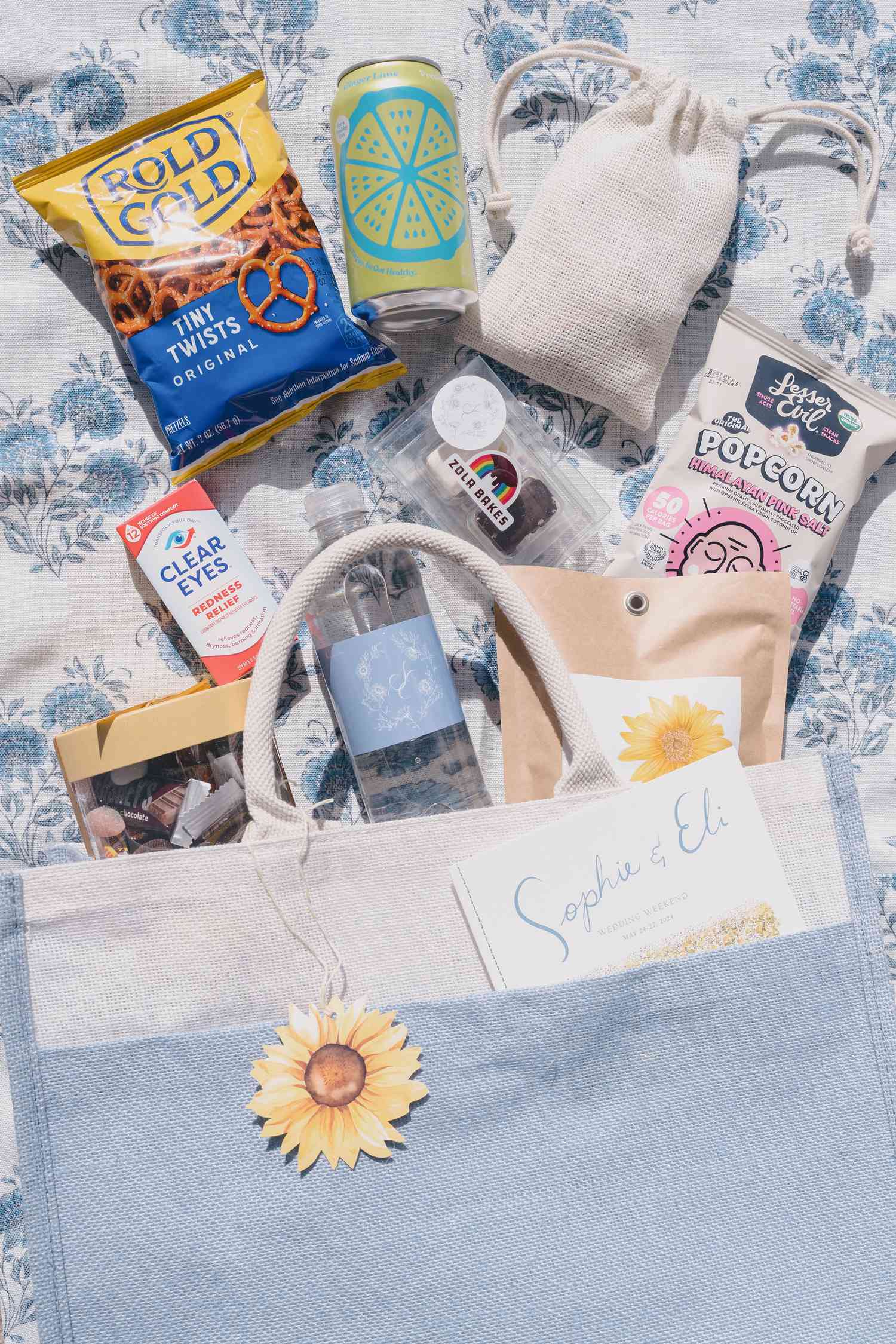 White and Blue Wedding Invitation Gift Bag With Water Bottle, Chips, Pretzels, Soda Can, and Candy