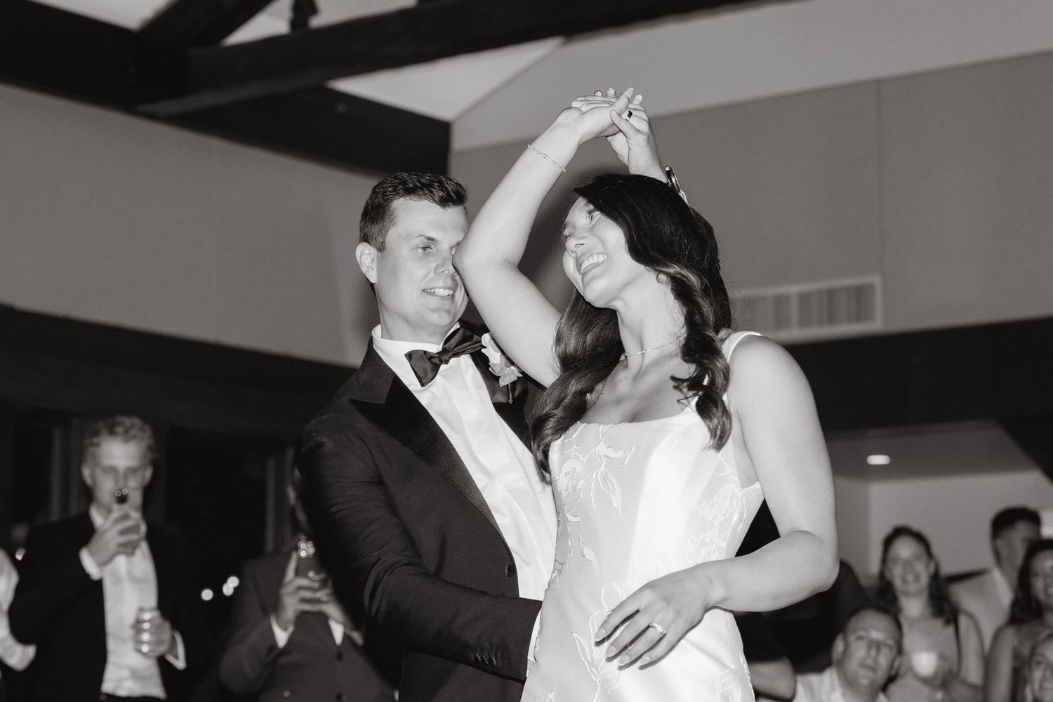 Kyla Ross in Wedding Dress With Straps and Square Neckline and Husband Justin Rittman in Tuxedo Sharing First Dance
