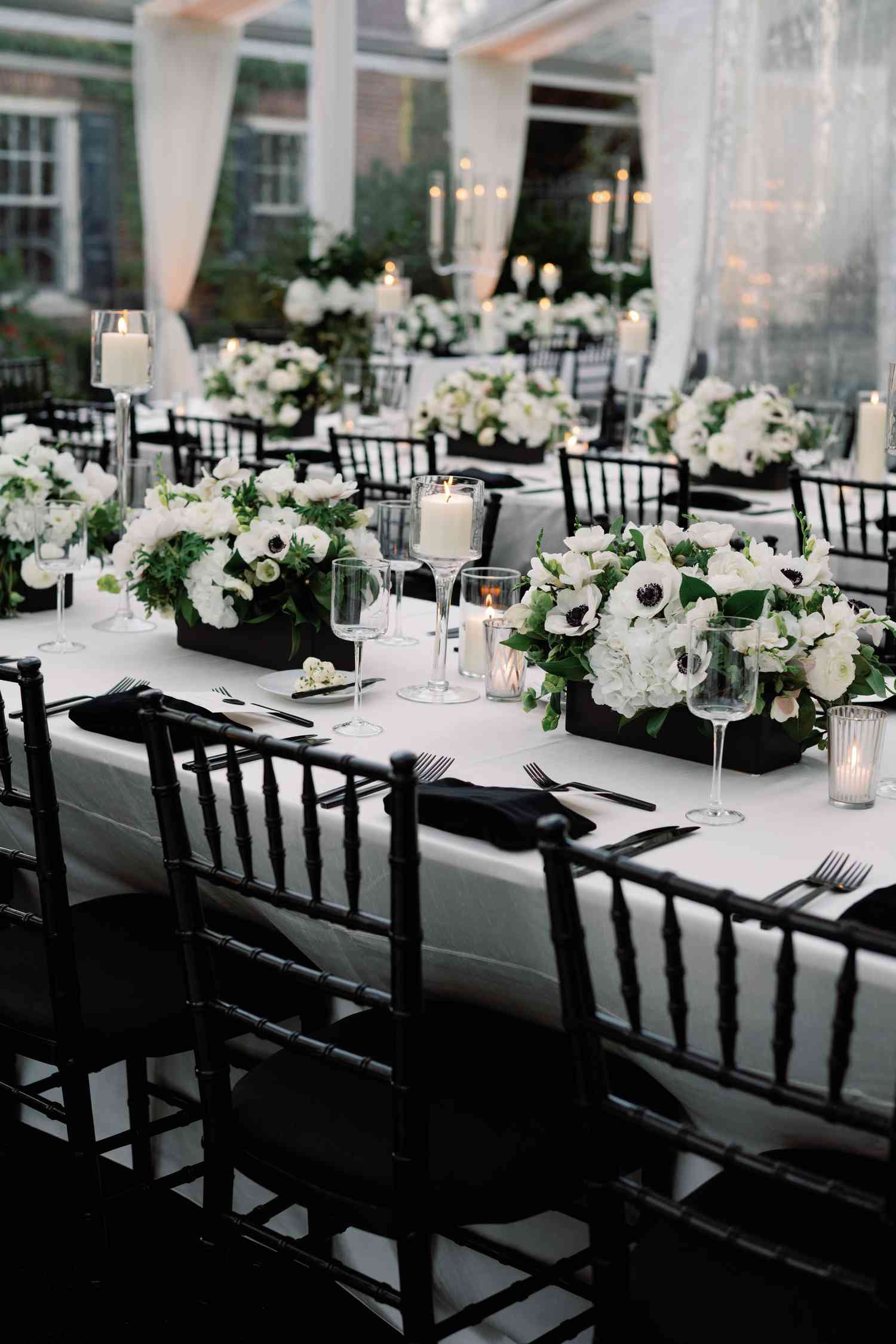 black and white reception decor with white floral and anemone centerpieces