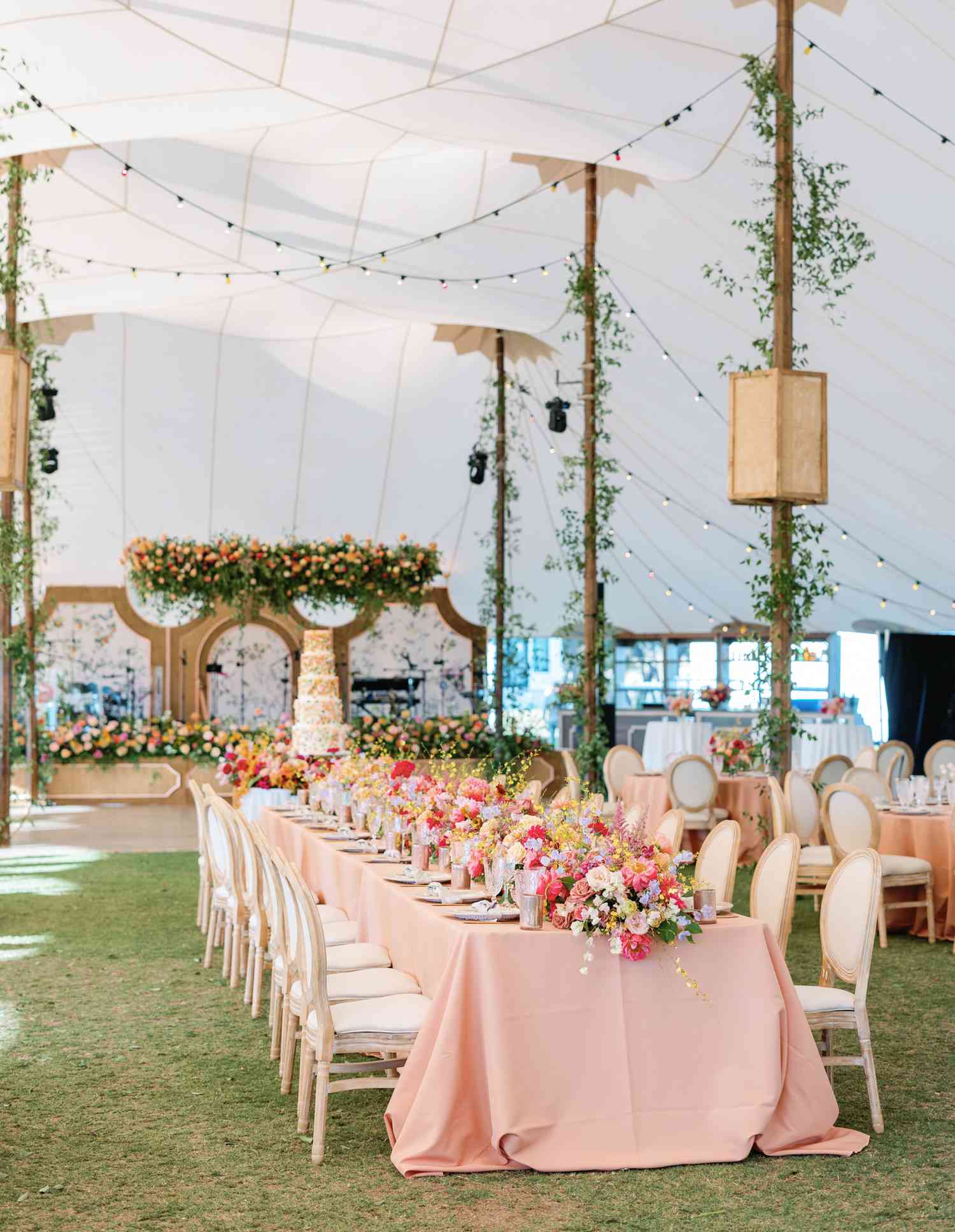 Pink Reception Tables With Colorful Flower Decor Under White Tent Wedding Reception