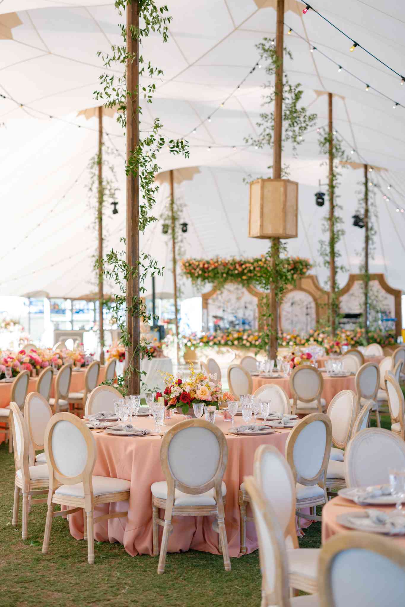 Pink Reception Tables With Colorful Flower Decor Under White Tent Wedding Reception