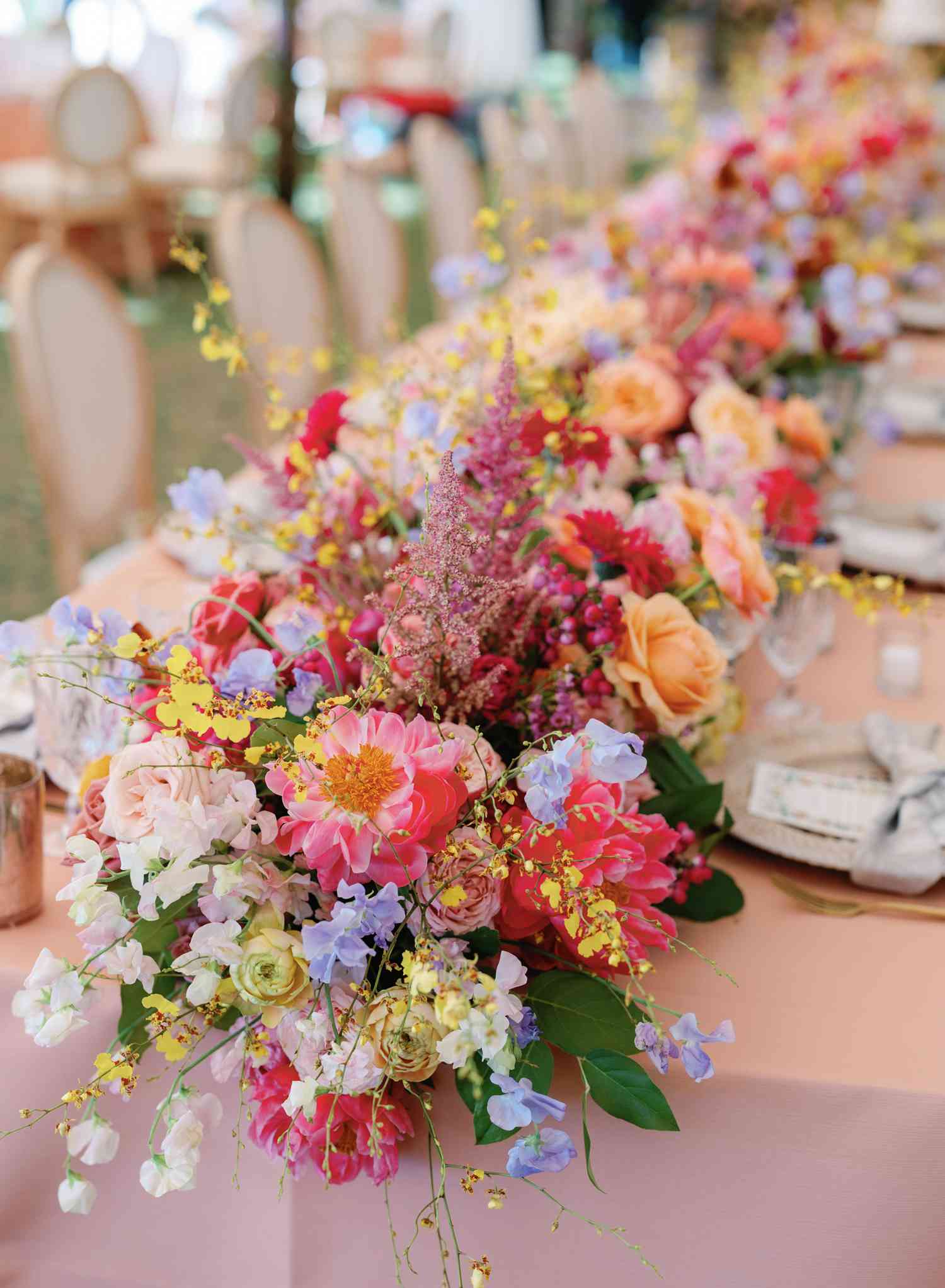 Close Up of Colorful Flower Decor on Pink Wedding Reception Table
