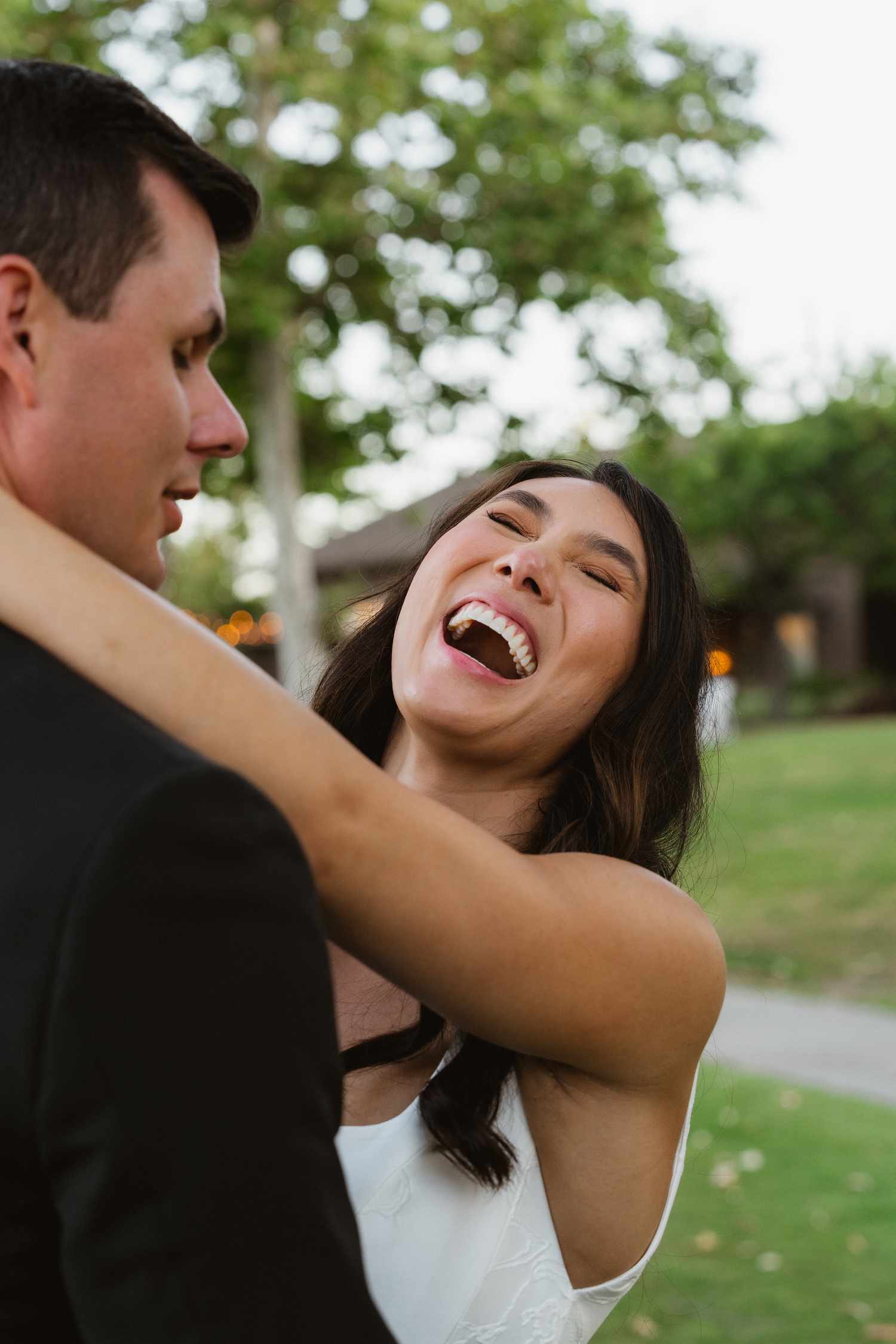 Kyla Ross in Wedding Dress and Husband Justin Rittman in Tuxedo Laughing