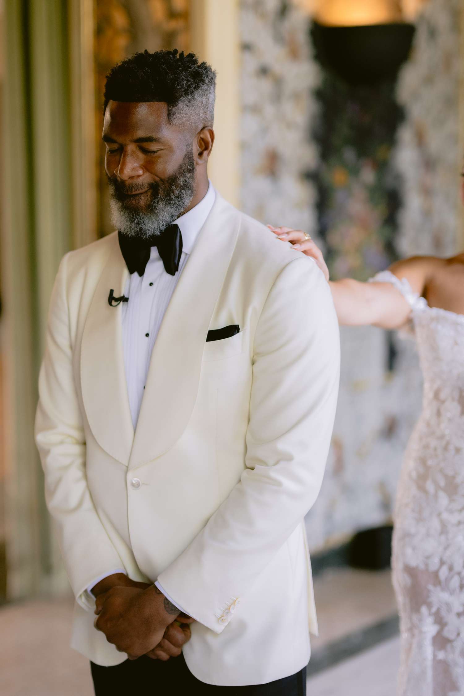 Groom in White Tuxedo Top and Black Pants Before Seeing Bride