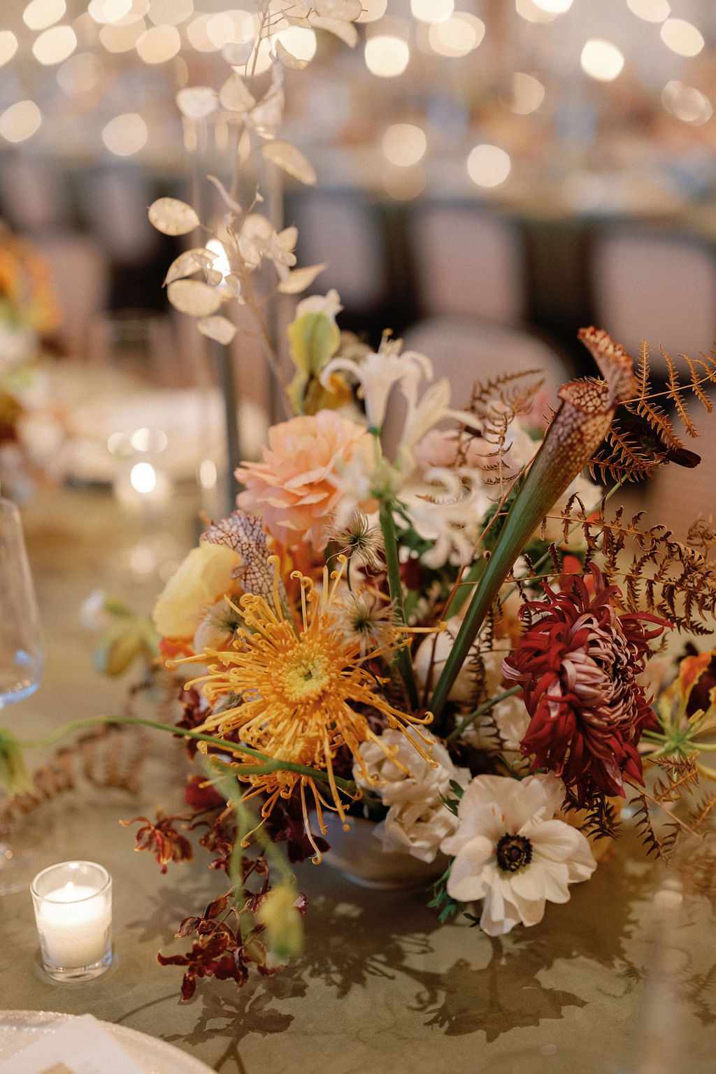 Colorful Flower Decor Next to Candles at Reception Table
