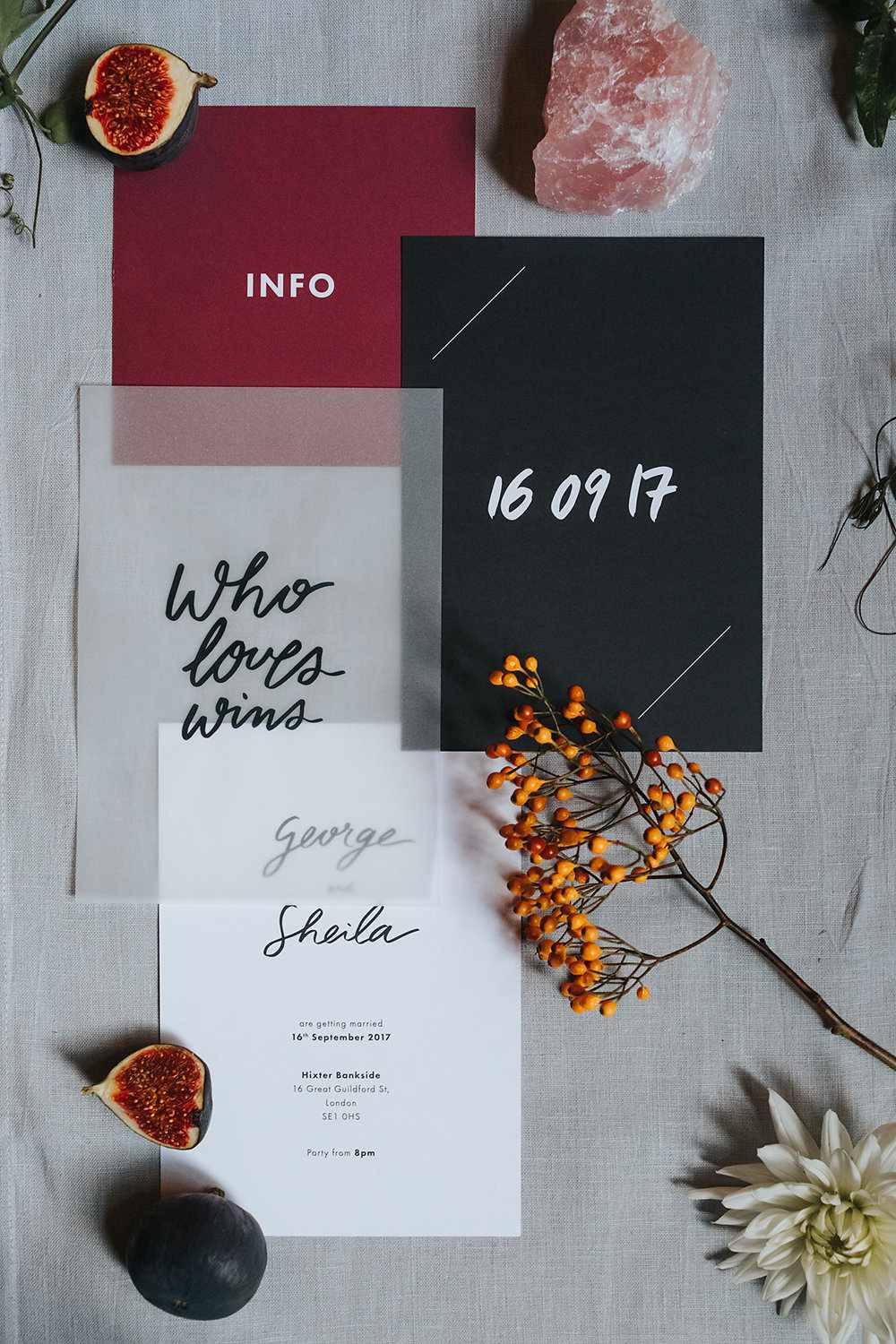Vellum invitations with black, white, and burgundy color scheme