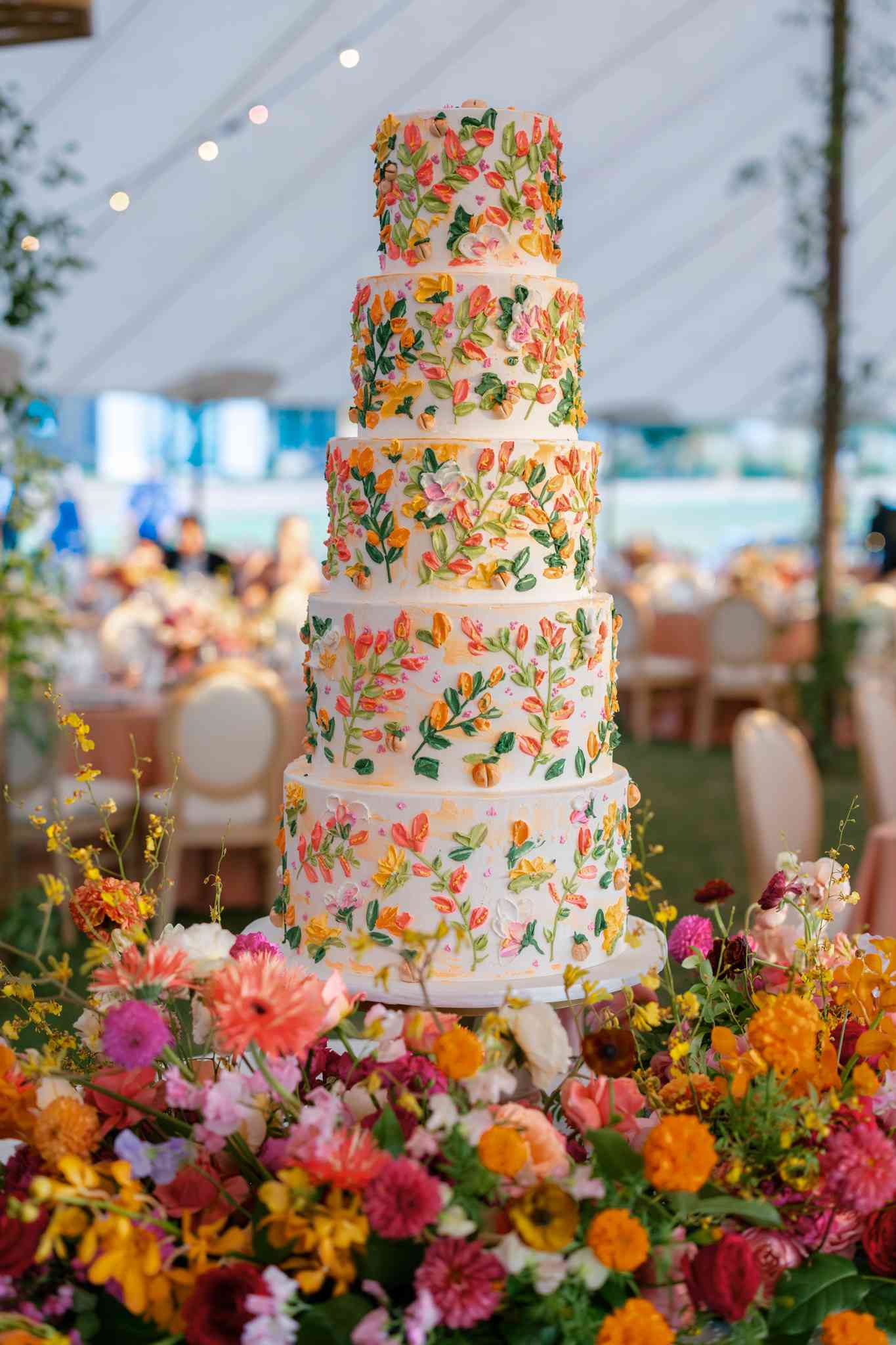 5 Tier Wedding Cake With Colorful Flower Details Surrounded By Colorful Flower Decor
