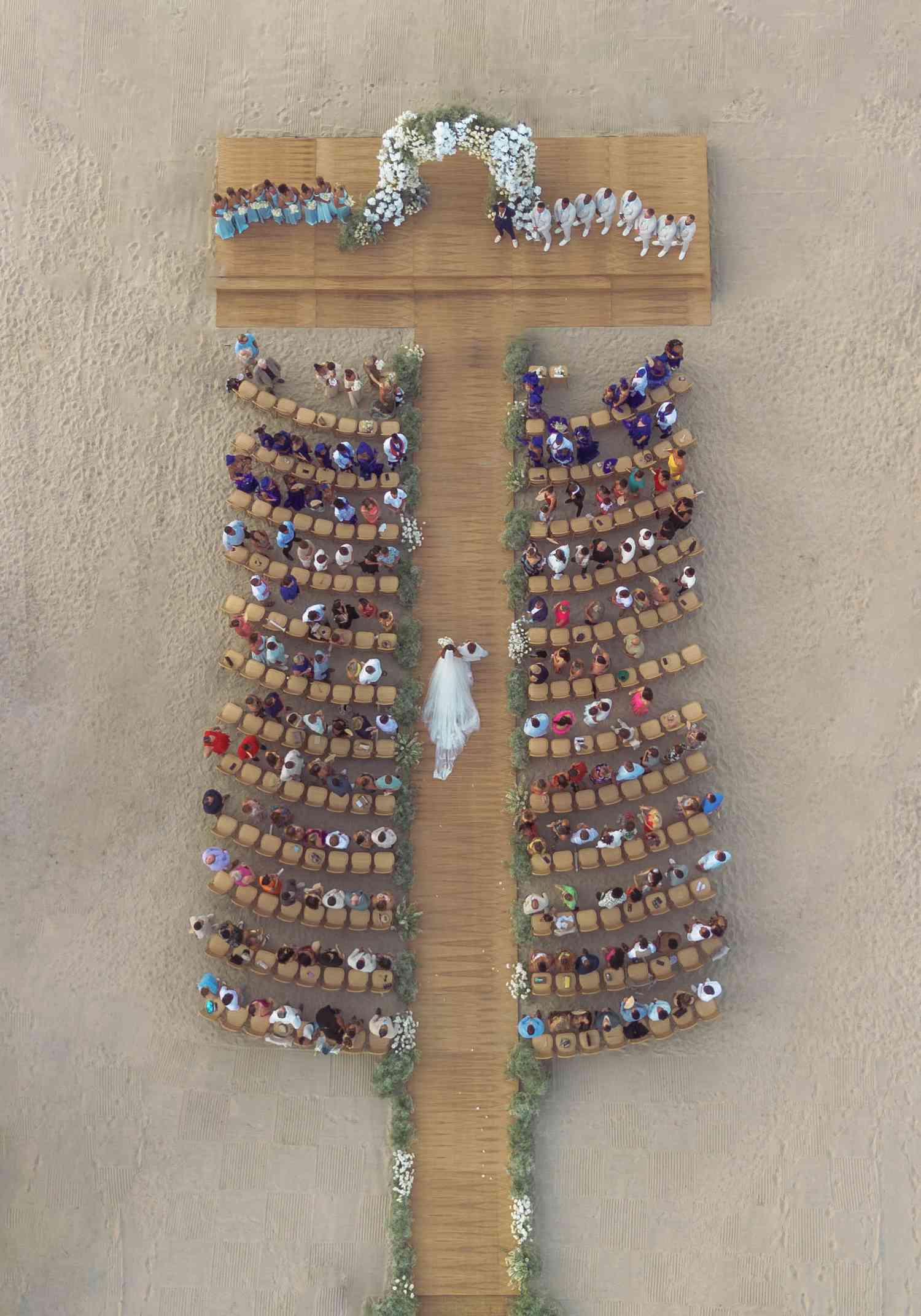 Aerial View of Guests at Wedding Ceremony With Bride Walking Down the Aisle