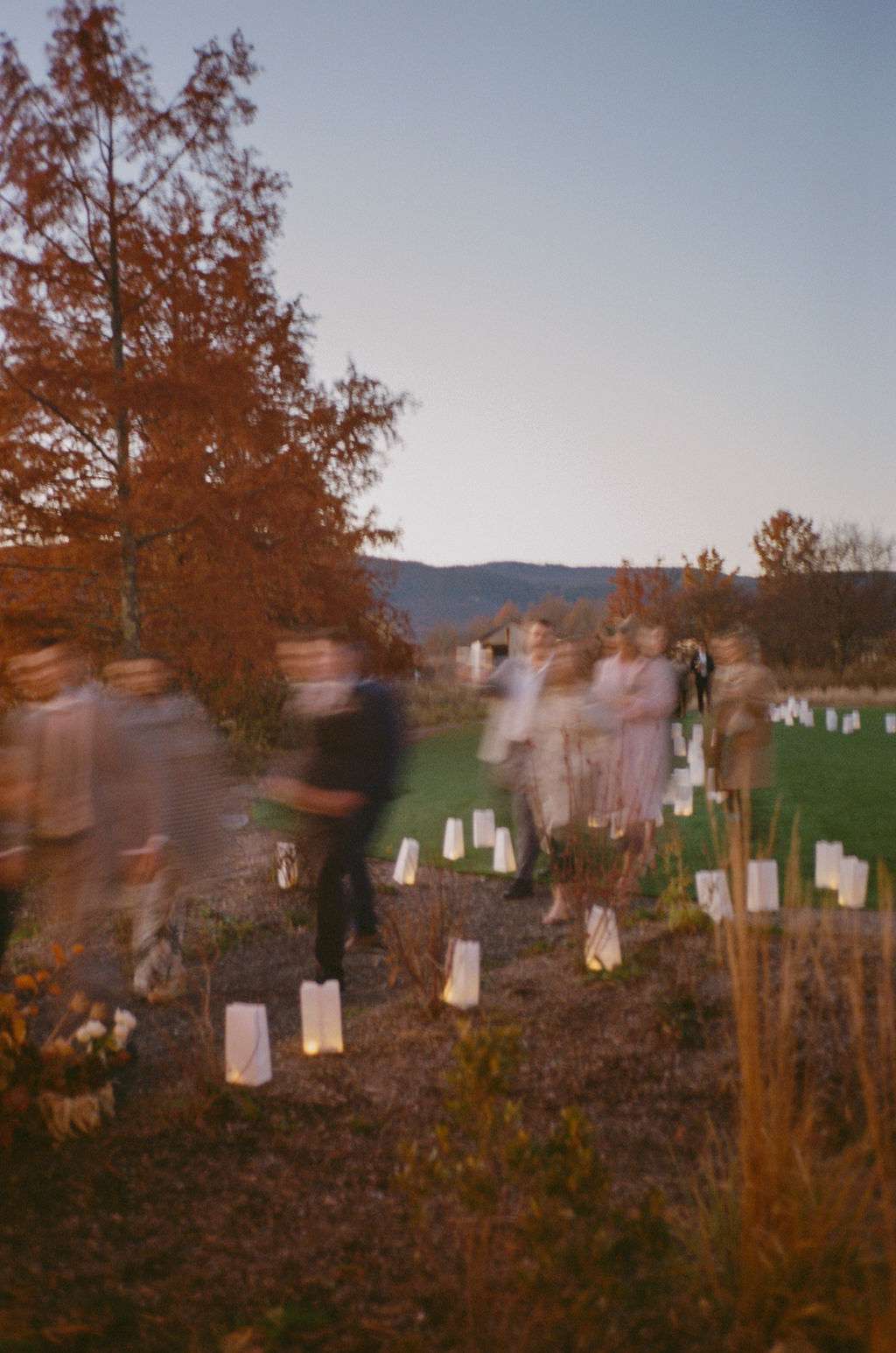 Long Exposure Image of Guests Arriving at Reception With White Lanterns on Ground