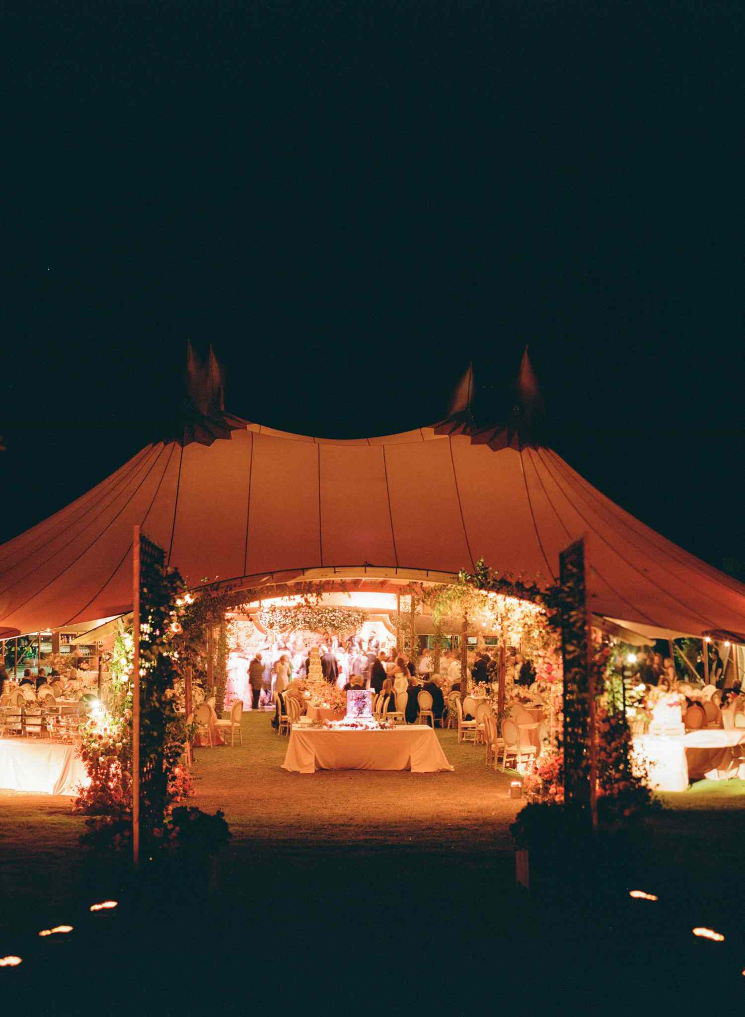 Wedding Reception in Tent Illuminated at Night