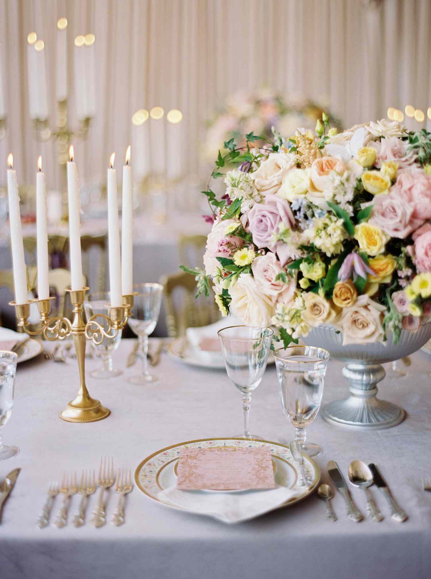 Wedding Reception Tablescape with Footed Centerpiece of Roses in Shades of Pink, White, and Yellow