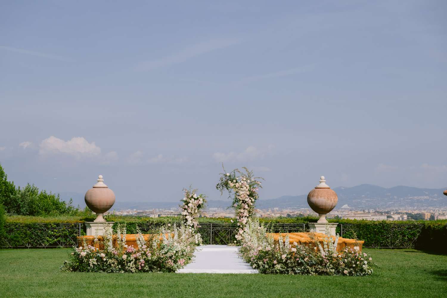 Wide Shot of Pink and White Flower Ceremony Decor at Outdoor Wedding
