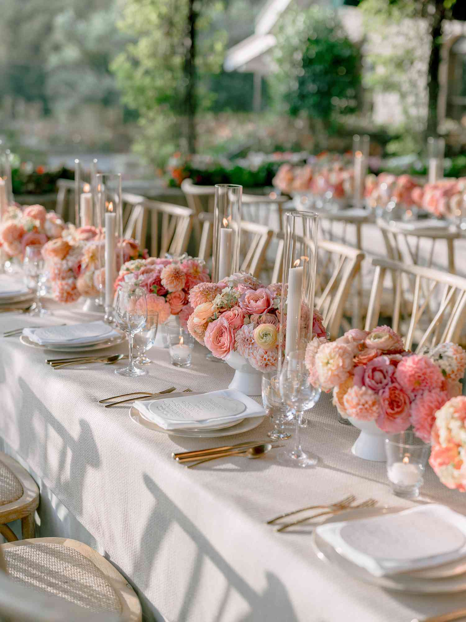 dining table with white table cloth and pink flower center pieces