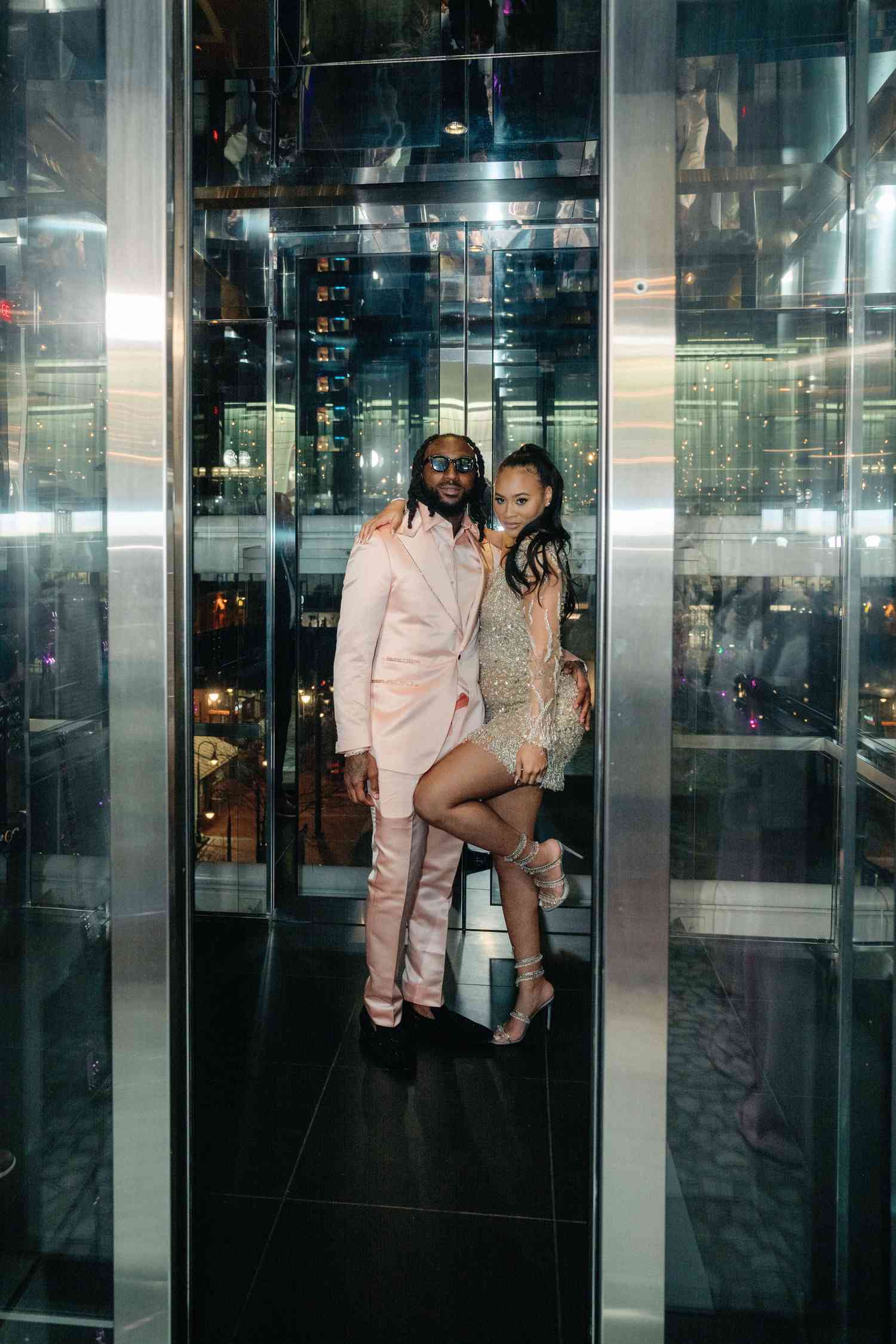 bride and groom couple in glass elevator