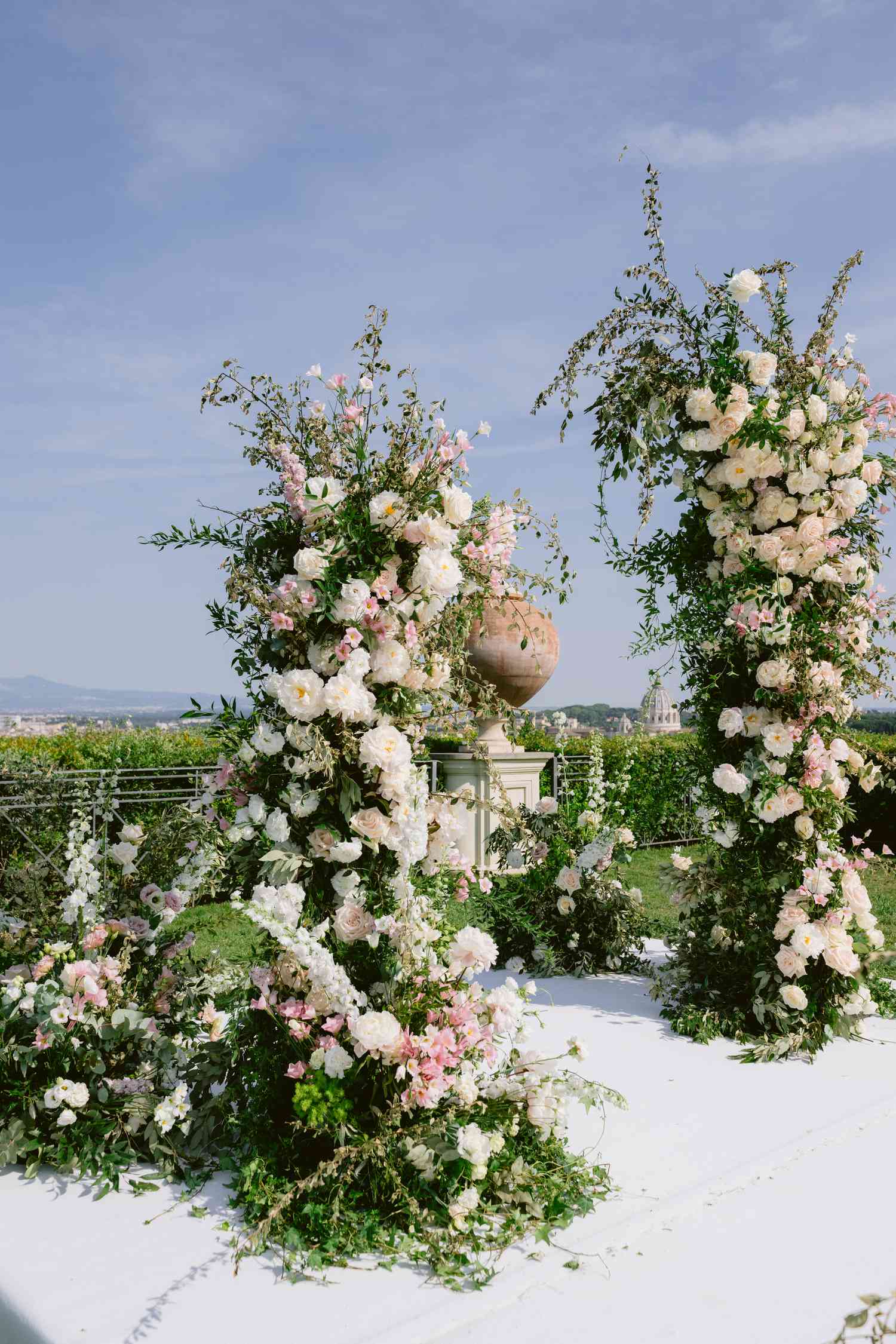 White and Pink Flower Pillars at Outdoor Wedding Altar on White Stage