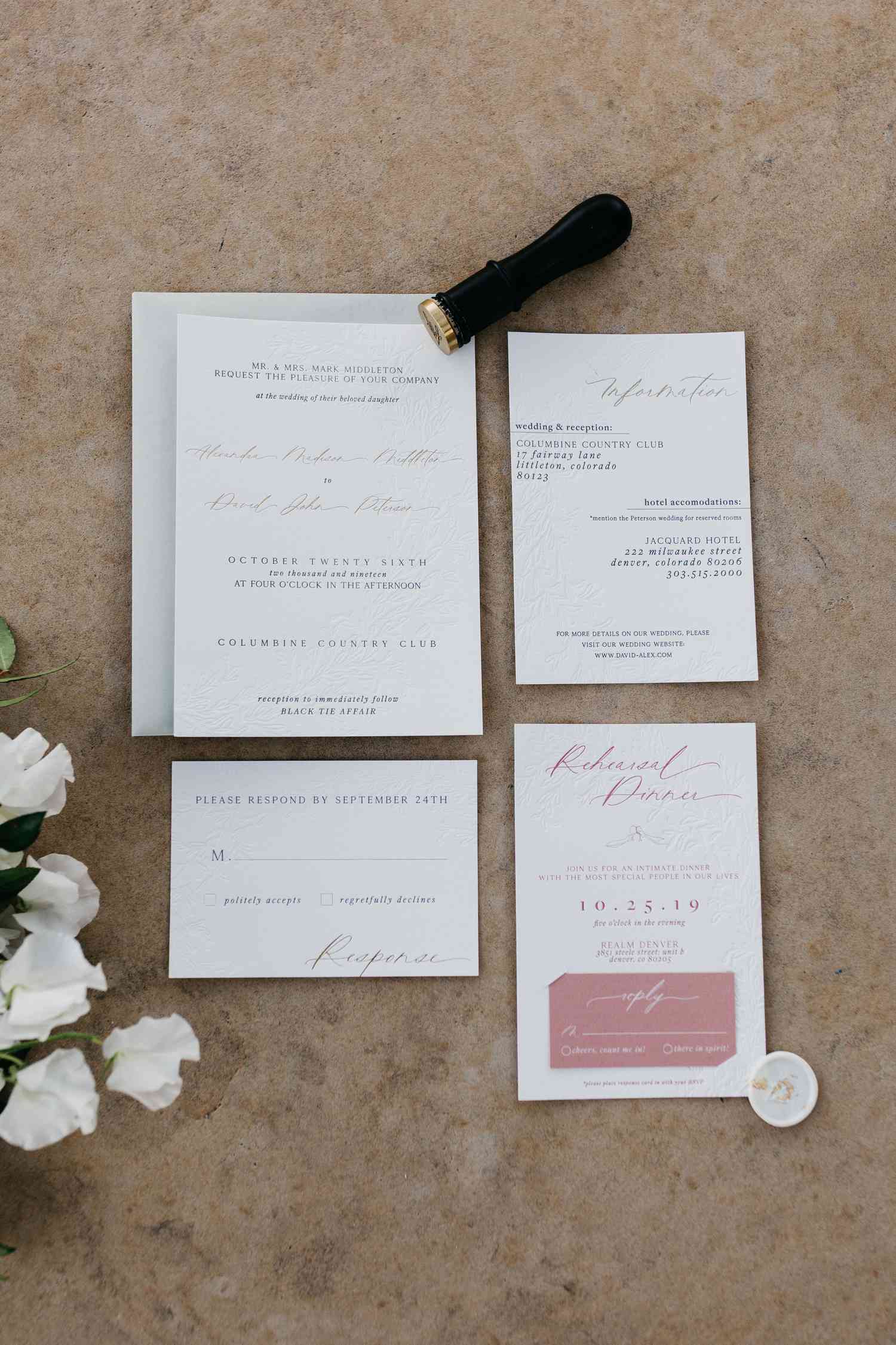 Embossed white fall wedding invitation suite with a wax seal and colorful font.